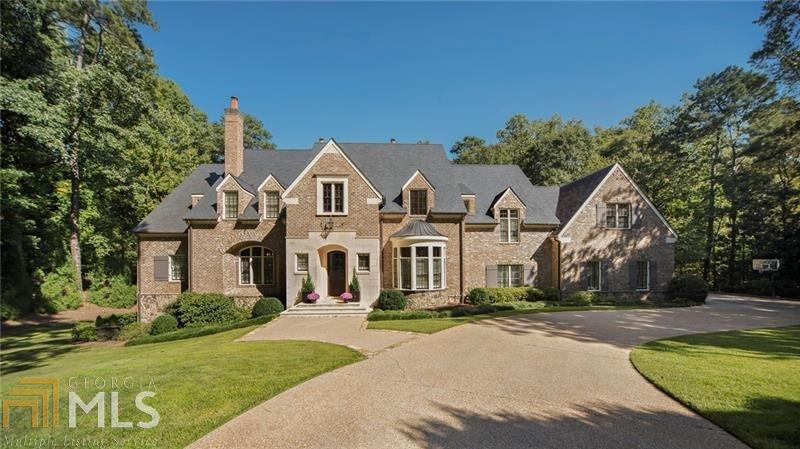 Exquisite Harrison Design timeless retreat that feels connected to the outdoors. This one-of-a-kind gated estate offers the perfect combination of sophisticated living and casual elegance. Everywhere you turn and look in this home, there's a gorgeous natural vignette through every window. The 2.4 acres of picturesque privacy invites you to relax under the covered veranda, play games in the flat backyard or lounge by the pool- this outdoor living area is ideal for entertaining. Inside, you are invited to host parties near the fireplace in the vaulted family room and cook with ease in this fully equipped kitchen, stunning cabinetry design, and endless storage space. The serene owner's suite is situated for privacy on the main level and features a sitting area, cast stone fireplace, lavish marble bathroom, and walk in closets. Plenty of room for play and sleep in the secondary bedrooms, and the daylight terrace level features a kitchen, wine cellar, guest suite and is ideal for rainy day play.