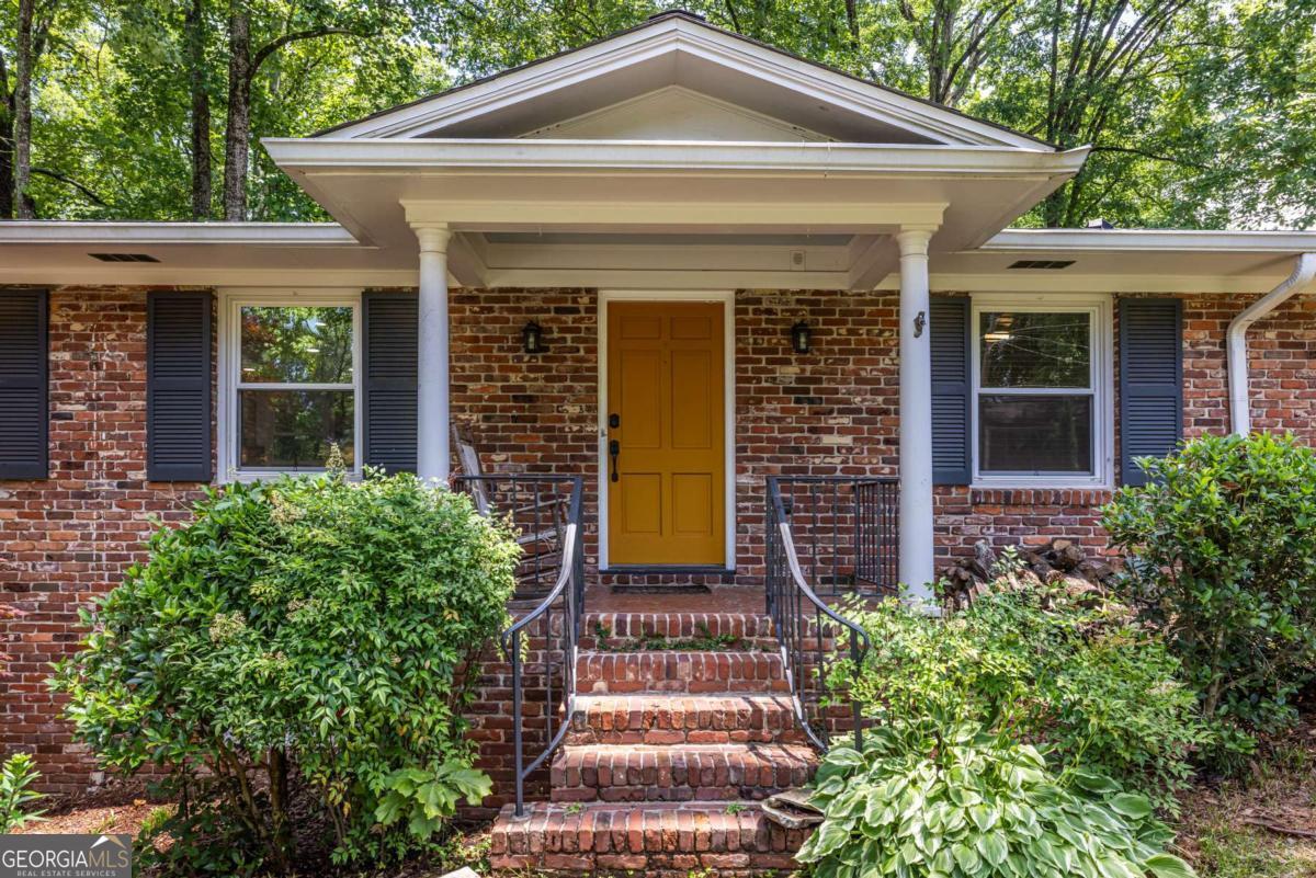Two homes in one! 3 bedrooms, 1 1/2 baths on main level, plus a full one bedroom, one bath, in-law suite on basement level - renovated to same standard as main level! Both levels completely renovated 10-12 years ago with timeless features such as marble kitchens, hardwood floors and open concept layouts, along with new windows and new electrical. (All permitted!) The main level kitchen features stainless JennAir appliances, painted custom cabinets, an island for sitting and/or prep, stainless vent hood, built-in microwave, gas cook-top, and wall oven. The main level has been completely opened up between the kitchen, dining and family rooms. There is a dedicated laundry on the main level, built-ins in the family room, and a great elevated patio with access from the family room and the kitchen. The patio is a great space to grill and create an inviting seating area. Both the full and half bath have also been completely renovated with timeless tile options. The basement is accessible from the main level plus private entrances from the driveway and backyard. Downstairs you will find a bright in-law suite complete with one-bedroom, family room, dining area, full bathroom, dedicated laundry, beautiful full kitchen with stainless appliances, marble counters, stainless vent hood, built in microwave, huge walk-in pantry, and bar/peninsula for more seating. Double glass doors lead you out to a private, brick patio area. Great care was taken in renovating this home. The driveway (includes a side parking pad) was replaced this year, the roof was replaced two years ago and all trees trimmed to meet current insurance standards. Close to The Path, downtown Tucker, Stone Mountain Park, downtown Decatur, Hwy 78, and I-285. This is 1393 Sagewood Circle!