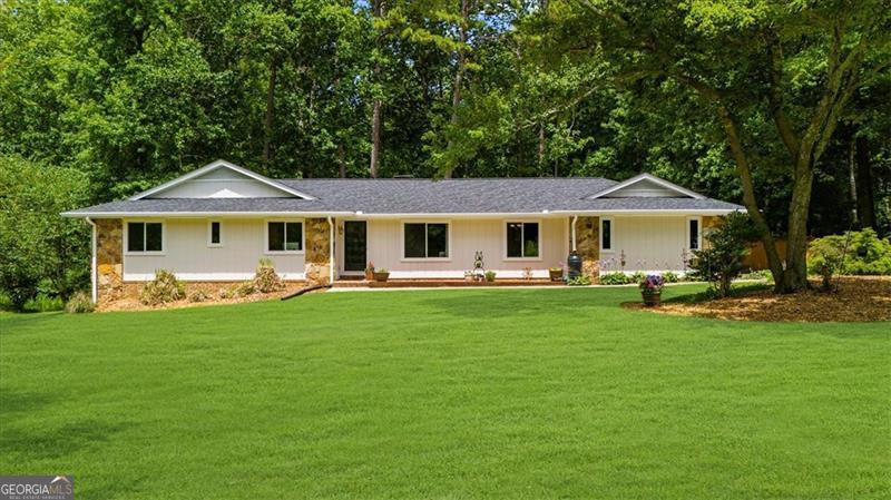 Welcome home to one of the BEST NEIGHBORHOODS in all of Roswell: Hunterhill! This smaller hidden gem is in a prime location, just a mile from downtown Roswell/Canton Street, a quick drive to Roswell area park, close to the River, on the edge of East Cobb and super close to so many great stores and restaurants. This ONE is a super easy choice as all the heavy lifting has been DONE for you. Freshly painted exterior, kitchen remodel, renovated bathrooms, basement remodel, new screened porch, new deck, new roof, newer HVAC, newer furnace, new windows throughout AND so much more! Full list of upgrades available. This well-maintained ranch home is a rarity in Roswell due to its big flat front yard and flat newly-fenced backyard with a large in-ground POOL, plus your own wooden built cabana for lots of fun! Outdoor living is premium here with the new deck, updated large screened porch with vaulted ceiling and walk out access from the basement with lots of additional backyard space as well. Natural light-filled interior with all new windows throughout to enjoy the views from your renovated kitchen including new quartz countertops, backsplash, range hood and sink, newly-painted cabinets, new lighting, new paint and newer high end stainless appliances. Vaulted ceiling in family room with fireplace overlooks back of the house, large formal living room greets you upon entering the home from the front with access into the separate dining room and then kitchen. Good-sized bedrooms on main level with updated jack-and-jill bathroom between secondary bedrooms and renovated owners' suite bathroom. Double your living space with updated basement including new paint, new flooring and new ceiling tiles. Large second family room or hang-out space in window-filled basement with a second fireplace. Basement also has a bedroom and full bathroom! Lots of additional storage space in the basement plus permanent attic stairs for easy walk-up access from the main level. Homes in this treasured neighborhood rarely come on the market. Don't miss this opportunity for easy living in a great neighborhood in the BEST location! No HOA.