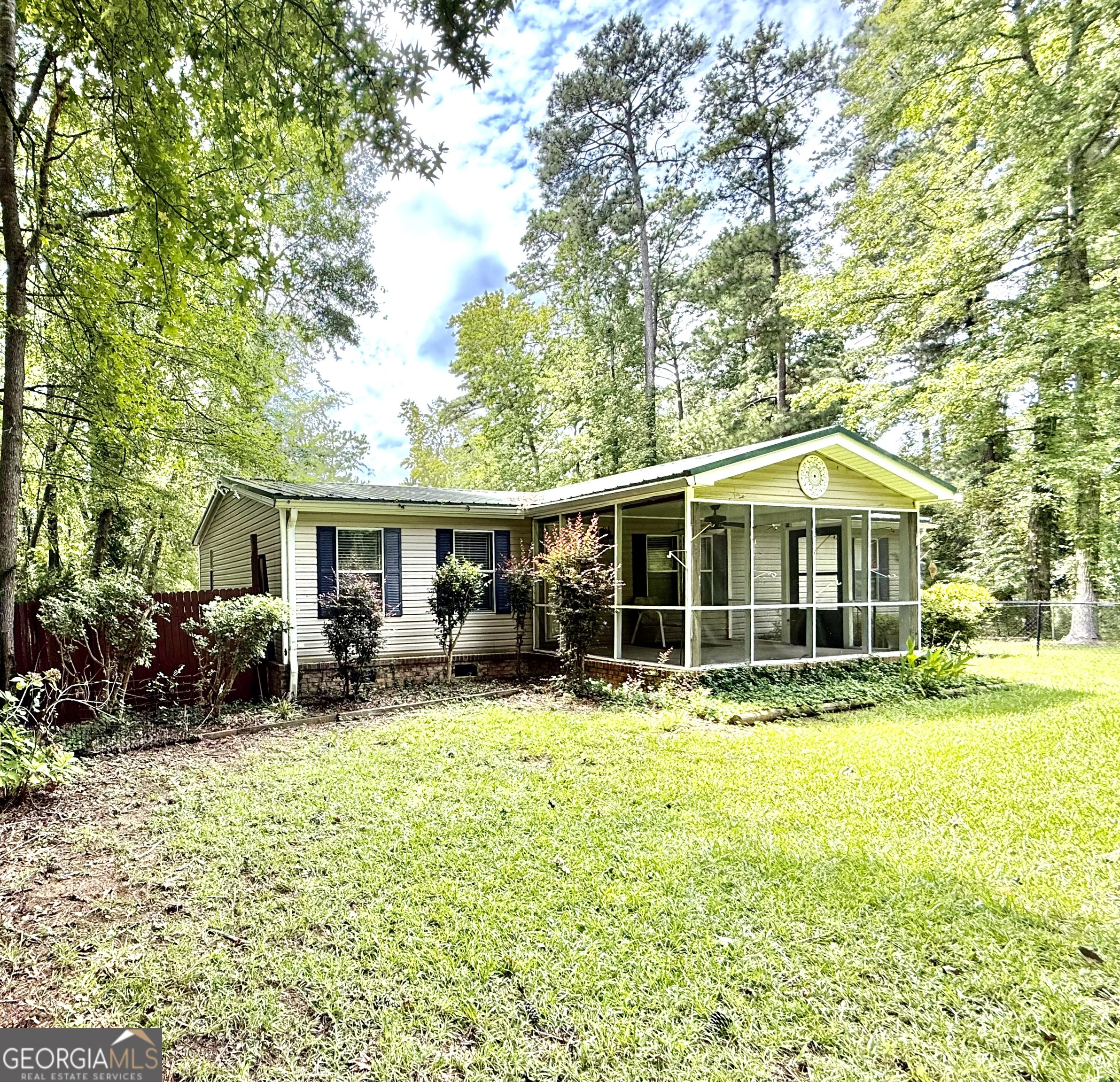 Looking to own an affordable Lake House on Lake Sinclair, now is your chance! Located 10 mins or less from Kroger and Walmart, Near Sincalir Marina. A 2002 modular home with 3 bedrooms and 2 full baths. Both bathrooms have been updated with a tile shower and new vanity. New LVP flooring throughout. It has screened in front porch and front yard is fenced in. Has a large deck on back of home that will be perfect for entertaining or watching the sun go down on Lake Sinclair. A big back yard is always a plus! it already has a dock waiting for you to enjoy as well. 96.22 water frontage. Brick underpinning, concrete footings and concrete beneath front porch and has a metal roof. Brand New Appliances. Seawall has been updated. This property is a lease strip $100 per year. It can be used as a VRBO. Call today for a showing!