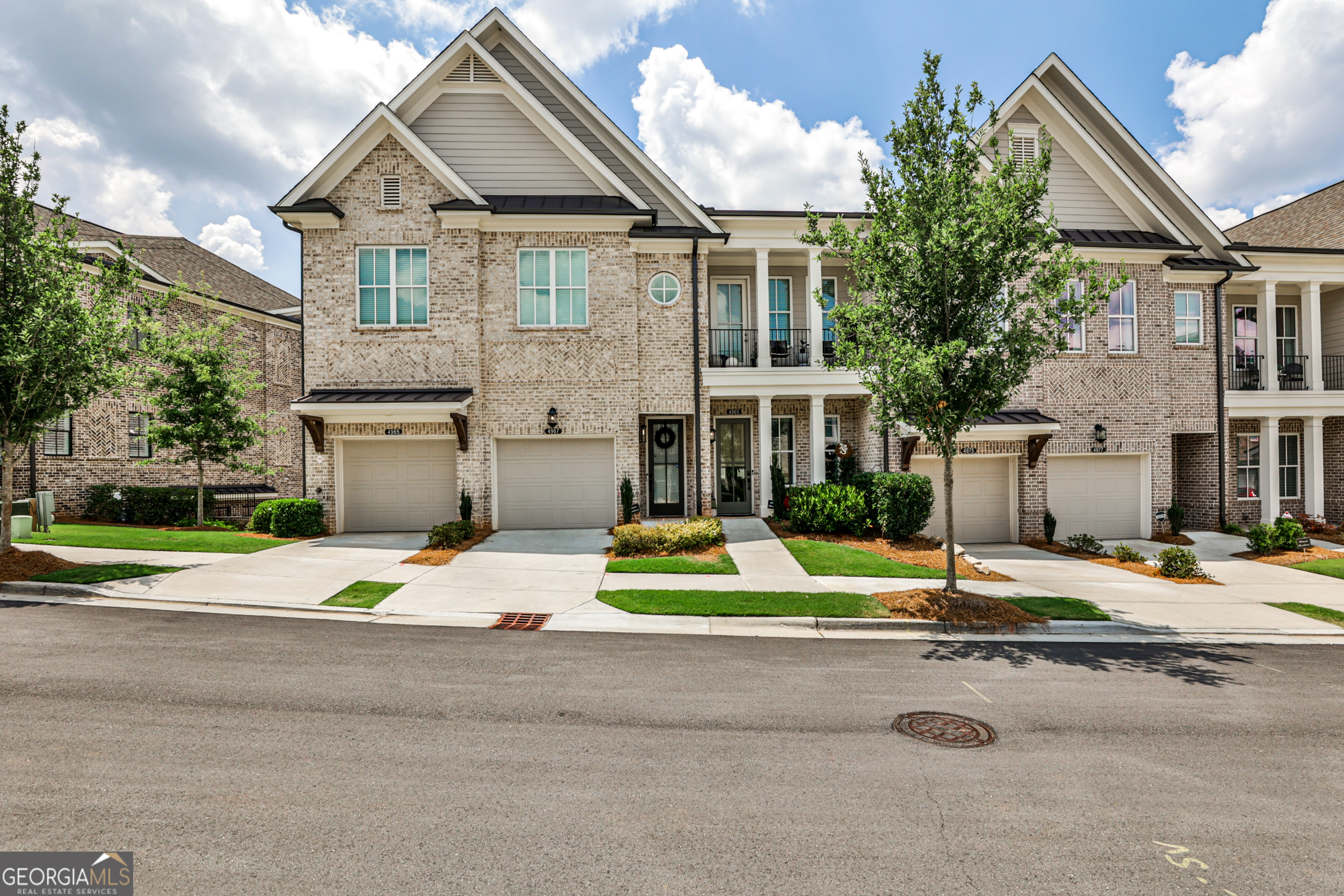 Welcome to 4965 Sealy Circle - a beautifully crafted, move-in ready condo nestled in the prestigious gated community of Waterside in Peachtree Corners. This immaculate 2-bedroom, 2-bath home offers the perfect blend of upscale finishes, functional design, and low-maintenance living - all just minutes from The Forum, top schools, and the scenic Chattahoochee River. Step inside to discover a bright, open-concept floor plan with soaring 10-foot ceilings, oversized windows, and designer touches throughout. The gourmet kitchen is the heart of the home, featuring Cambria Marble countertops, a large island with seating, stainless steel appliances, and a walk-in pantry. The spacious living room flows seamlessly to a private covered patio - perfect for relaxing or entertaining. Waterside is a gated, master-planned community offering luxury amenities including a resort-style pool, clubhouse, fitness center, pickleball courts, walking trails, and direct access to the Chattahoochee River. HOA includes lawn maintenance and exterior upkeep for a lock-and-leave lifestyle. Don't miss your opportunity to live in one of Peachtree Corners' most desirable communities - where nature, luxury, and convenience come together.