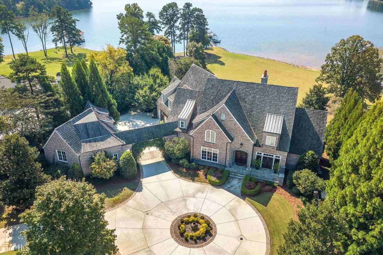 Truly one of the most elegant and refined estates on Lake Lanier is now available for your living and recreational desires. From sunrise to sunset, the day greets you with vast, open views of serenity and enjoyment. Located in the quieter waters in the north end of the lake, this deepwater, level lot of the Chattahoochee Country Club area resonates with staycation. The main floor has everything you need for everyday living to include a separate office space and study should you need to work for home,while still affording additional elbow room in the upper level and terrace level for those days we are all too familiar with when family and friends come for extended visits. And should you need additional space to grow or get away, there's even unfinished space over the garage for a workroom or additional bedroom. Multiple outdoor entertaining areas, in addition to a large yard just calling for a pool, expands your living spaces to enjoy the lake and all it brings to make life just a little bit sweeter.