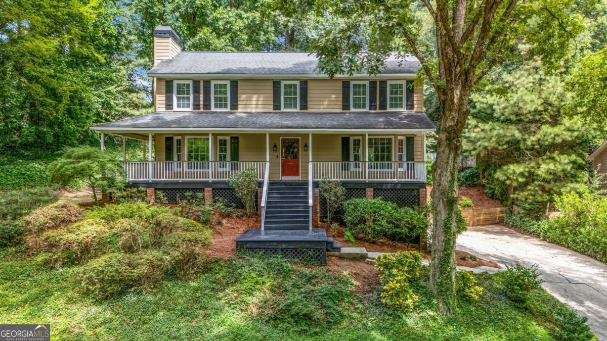 Welcome to this East Cobb gem, where a charming wrap-around front porch and a covered screened rear porch set the stage for true Southern living. Perfectly situated in a sought-after swim and tennis community with top-rated schools including Garrison Mill, Mabry, and Lassiter, this home blends comfort, style, and convenience. Inside, the spacious floor plan offers flexible formal and casual living areas, ideal for entertaining, working from home, or everyday family life. The beautifully updated kitchen features abundant cabinetry, granite countertops, stainless steel appliances, and a sunny eat-in area overlooking the deck, screened porch, and terraced backyard, creating the perfect setting for relaxation, gardening, or outdoor gatherings. Upstairs, generously sized bedrooms feature great closets, brand-new carpet, and an updated hall bath. The oversized primary suite is a true retreat with a cozy fireplace, dual walk-in closets, and a renovated spa-like bath with separate vanities. The finished basement adds versatile living space with a bonus room featuring built-ins, along with a workroom in the garage for hobbies and projects. The neighborhood offers a pool, playground, and tennis courts, providing all the amenities without the upkeep. Convenient to downtown Roswell with the benefit of Cobb County taxes, this home truly has it all.