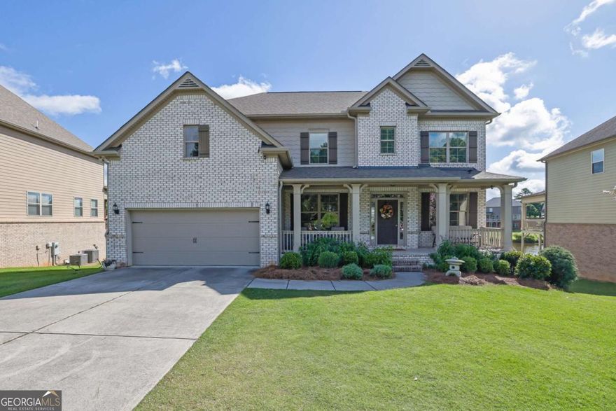 Welcome to your lakeside haven in Cumming, a traditional home upgraded with over $220,000 in renovations. This 4,831-square-foot residence offers 6 bedrooms and 5.5 bathrooms, with an open-concept main living area featuring  hardwood floors-perfect for family life or entertaining. The gourmet kitchen showcases bright, open design, granite countertops, a gas cooktop, and double ovens, making family meals and hosting effortless. Step onto the back deck to find a cozy outdoor fireplace and inviting living space, all overlooking a tranquil lake. The fully finished basement includes its own kitchen and a dedicated laundry room, plus spectacular lake views. Walkout patio for lake activities or a peaceful morning coffee. The oversized primary suite features a built-in home gym or reading nook for flexible use. Homes has a built-in Tesla charger for EV charging and an advanced home water filtration system for pristine, filtered water.    Residents enjoy exclusive access to the community pool, a perfect amenity for an active lifestyle and socializing with neighbors. This home blends traditional elegance with modern conveniences in a picturesque lakeside setting. Whether you're relaxing on the deck, pursuing outdoor activities, or entertaining, you'll find the ideal backdrop for your lifestyle.