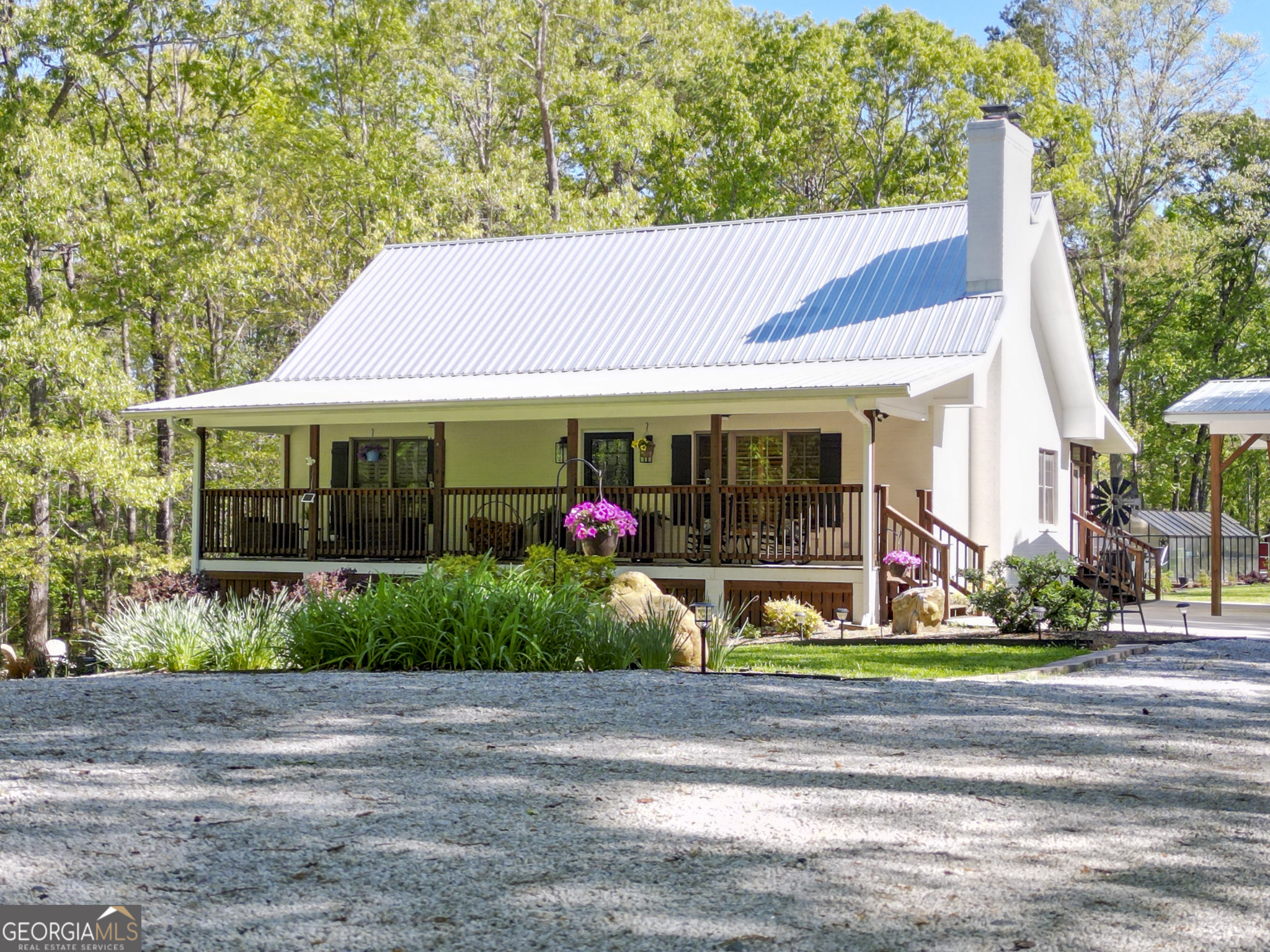 APPOINTMENT ONLY:Hidden Oasis Retreat - Modern 3 Bed, 2 Bath Craftsman Farmhouse on 49.98 Acres Welcome to your secluded sanctuary nestled amidst the serene woods. This captivating 3-bedroom, 2-bathroom modern craftsman-style farmhouse promises an exceptional lifestyle on nearly 50 acres of pristine land. Nature's Paradise: Discover your own private waterfall along the tranquil creek, complete with a picturesque antique waterwheel. Adventure awaits with hiking trails that wind through the property, featuring bridges over the creek. For those seeking possible potential for off-grid living, this property is ready with a 20kw solar panel system with enphase battery, private well with a commercial-grade pump, and a 3-stage carbon filter. Year-Round Comfort: Enjoy year-round comfort with a couple of heating options, including a newer HVAC system and two cozy wood stoves.Green Thumbs Welcome: A flourishing garden area awaits your green thumb, complete with two large garden boxes with drip irrigation and a fully equipped greenhouse. Plus, a commercial-grade irrigation system with 15 stations ensures your garden thrives. Eggcellent Farm Life: Your fine-feathered friends will feel right at home in the spacious chicken coop, ensuring a steady supply of farm-fresh eggs. Ultimate Hobbyist's Dream: A massive 1500 square foot detached garage with a 12-foot shed roof encircling the perimeter awaits your projects and passions. Boasting six roll-up doors, a concrete floor, and rough-in plumbing, this space is perfect for car enthusiasts and hobbyists alike. Prime Location: Despite its secluded feel, you're just 5 miles from the City of Westminster and 4 miles from the Chau-Ram County Park, offering access to the Chauga River. Walhalla, a charming Southern town, is within 10 minutes, providing essential amenities and local attractions.High Speed Internet with Upcountry Fiber. Nature Lover's Paradise: Immerse yourself in Oconee County's natural beauty, with nearby attractions including Issaqueena Falls, Yellow Branch Falls, and Station Cove Falls. Explore the Stumphouse Tunnel and the Stumphouse Tunnel Mountain Bike Park or embark on the Palmetto Trail, South Carolina's longest pedestrian/biking trail. Lakes In Upstate: Within a 40 minute ride Enjoy area access to three of the South's best lakes, Lake Jocassee ,Lake Keowee and Lake Hartwell for boating, fishing, and water recreation. Don't miss this incredible opportunity to own your private nature preserve while staying close to all the amenities and attractions Oconee County has to offer. Discover endless possibilities in this extraordinary property! Schedule your viewing today and make this paradise your own.