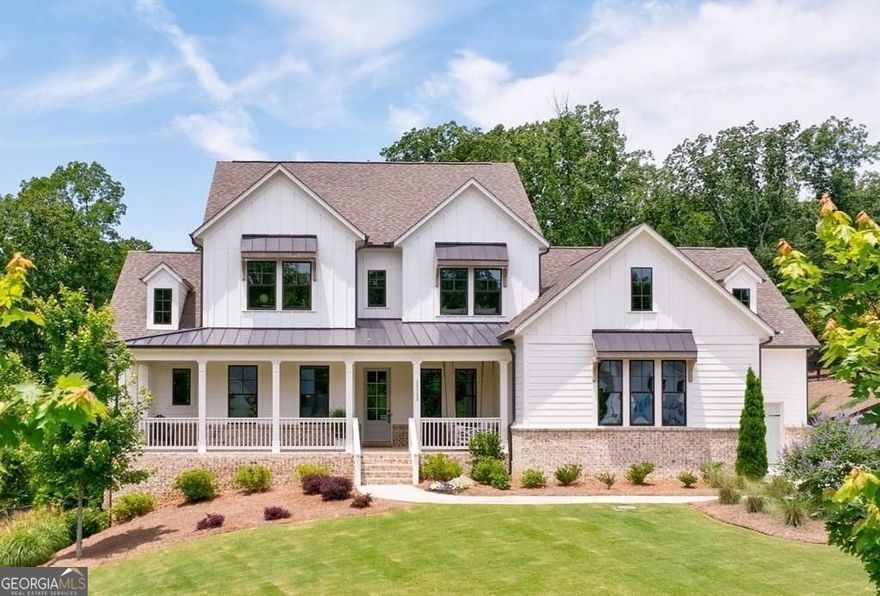Welcome to this stunning five-bedroom, four-and-a-half-bathroom residence located in the highly acclaimed Cambridge school district within Milton's sought-after Milton Run community. Nestled on a premium, fully fenced 1+ acre lot with mature hardwoods, this like-new home offers privacy, elegance, and thoughtful design inside and out. A charming wrap-around front porch with chevron-patterned brick welcomes you, while an expansive covered back porch overlooks the private backyard-perfectly positioned for a future pool or outdoor entertaining. The main level boasts a unique and functional floorplan featuring a spacious Primary Bedroom Suite, a private ensuite guest room, a dedicated office, and open concept living and dining areas. The chef's kitchen is equipped with top-of-the-line stainless steel appliances, including a built-in SubZero refrigerator, six-burner professional range top, double ovens, and an oversized island with seating. Thoughtful extras such as soft-close cabinetry, central vacuum, and an automatic dustpan elevate the everyday experience. Upstairs, you'll find an oversized loft offering a second living space, along with three additional bedrooms-all with custom-built walk-in closets. Bathrooms are beautifully appointed with tile to the ceiling, frameless glass showers, and stone countertops. The unfinished terrace level features soaring ceilings and offers a blank canvas for your dream basement. This is luxury living at its finest in one of Milton's premier communities.