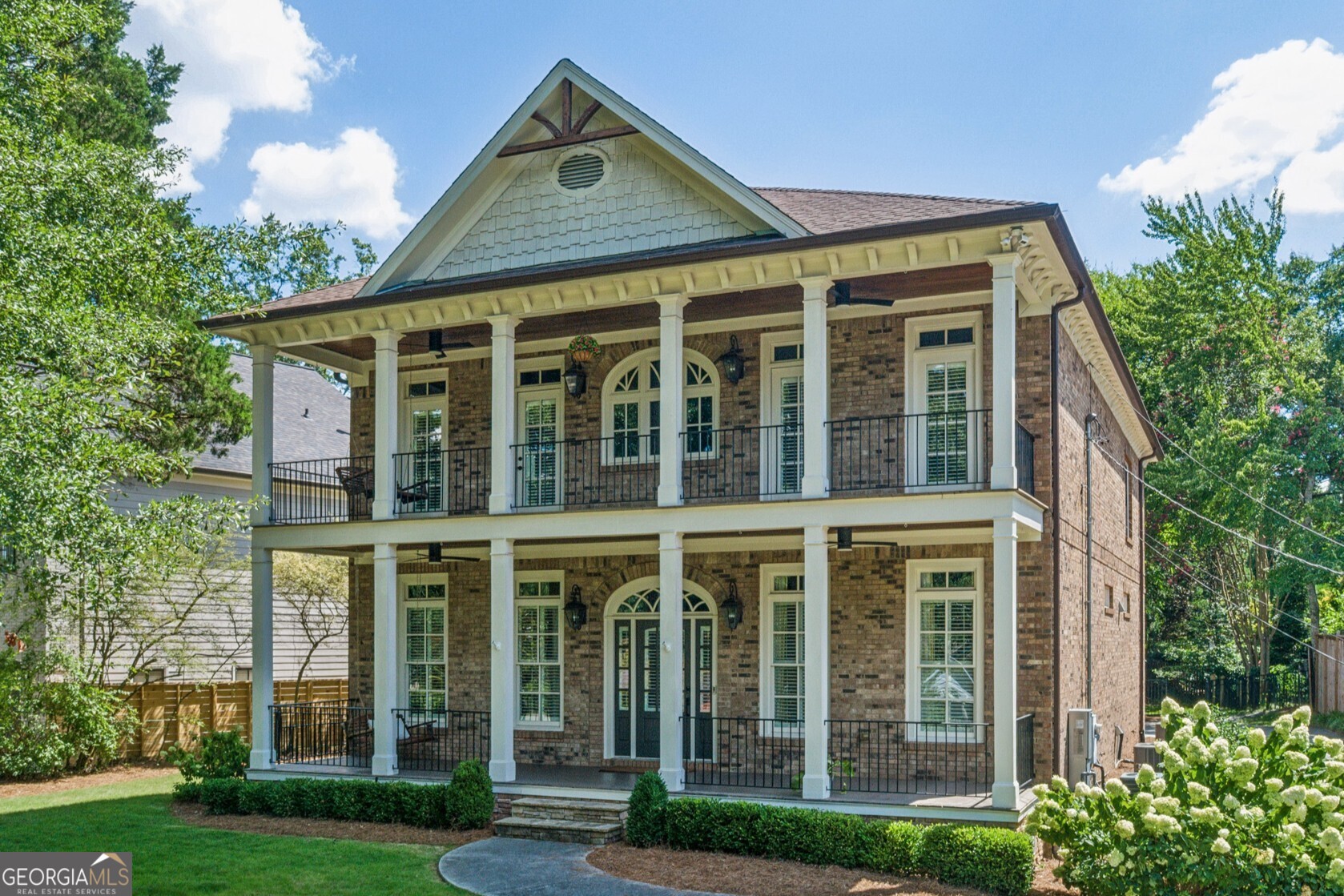 Welcome to this Stunning Custom Brick Home in the Heart of Brookhaven where Quiet Luxury meets Unmatched Convenience. Perfectly perched on a hilltop on a peaceful street, this show-stopping residence offers the rare opportunity to live just steps from the Brookhaven Farmers Market, Fernwood Park, the local library, and the buzzing shops and restaurants of Dresden Village. From the moment you arrive, the curb appeal is undeniable. A Rare Double Veranda Porch with Tongue-and-Groove Ceilings and Cooling Fans offers the perfect perch to sip coffee, wave to neighbors, and watch the quiet rhythm of the community unfold below. It's the kind of porch that makes you pause and stay awhile. Inside, Sophistication and Functionality shine in every corner. A Two-Story Foyer with Oversized Windows welcomes natural light to pour into the airy, open layout, where 10-Foot Ceilings, Detailed Crown Molding, and Rich Hardwood Floors set the tone for elevated living. To your left, a Handsome Office with Arched Built-Ins creates a true work-from-home retreat. The Living Room is both Stylish and Inviting, featuring a Classic Brick Fireplace, Custom Built-Ins, and Coffered Ceilings. At the Heart of the Home, the Chef's Kitchen is a true showpiece outfitted with a Wolf Range and Custom Hood, Quartzite Countertops, Double Oven, Butler's Pantry, Wine Cooler, and a Statement Island for gathering. White Zellige Subway Tile and Crisp Cabinetry deliver a timeless, tailored finish. A Casual Breakfast Nook opens to the kitchen, while a Formal Dining Room with Wainscoting and Oversized Windows adds elegance for entertaining. A Stylish Powder Room completes the main level. Upstairs, the Oversized Primary Suite offers a Serene Escape with Room for a Sitting Area, a Built-In Wet Bar for your morning coffee, and Two Massive Walk-In Closets. The Spa-Like Bath features Marble Tile, a Soaking Tub, and a Steam Shower worthy of a five-star retreat. Three Additional Spacious Bedrooms and Two Full Baths round out the upper level, ideal for families or guests. The Fully Finished Daylight Terrace Level is made for Entertaining with a Large Living Space, Built-In Sound System, Wet Bar framed by Brick Archways, and Direct Access to a Charming Outdoor Patio. An Additional Bedroom and Full Bath provide the perfect guest suite, while an Unfinished Space offers flexibility for a Home Gym, Workshop, or Extra Storage. Out back, a Covered Patio with a Built-In Fireplace and Ceiling Fan allows for Year-Round Outdoor Living. The Flat, Fully Fenced Backyard is perfectly manicured and ideal for play, pets, or your dream garden. American Boxwoods, English Ivy, and Lush Zoysia Grass supported by a Modern Irrigation System create a landscape that is both Low-Maintenance and Magazine-Worthy. A Rare Three-Car Garage and Attic Storage ensure space for everything. And best of all, this incredible home is just a Sidewalk Stroll from Everything that makes Brookhaven special from the Saturday Farmer's Market to Sunset Cocktails at Valenza to Boutique Shopping and Local Favorites along Dresden. You're also moments from Incredible Restaurants like Haven, Verde Taqueria, Dixie Q BBQ, Vero Pizzeria, Grindhouse Burgers, and Honeysuckle Gelato with even more openings coming soon. Grab your essentials from Savi Provisions, hop on the nearby Brookhaven MARTA Station for a quick commute, or look forward to the brand-new Brookhaven City Hall opening this summer. This is not just a house it's a lifestyle. A True Brookhaven Beauty with every Luxury Detail, in one of Atlanta's most Sought-After Neighborhoods.