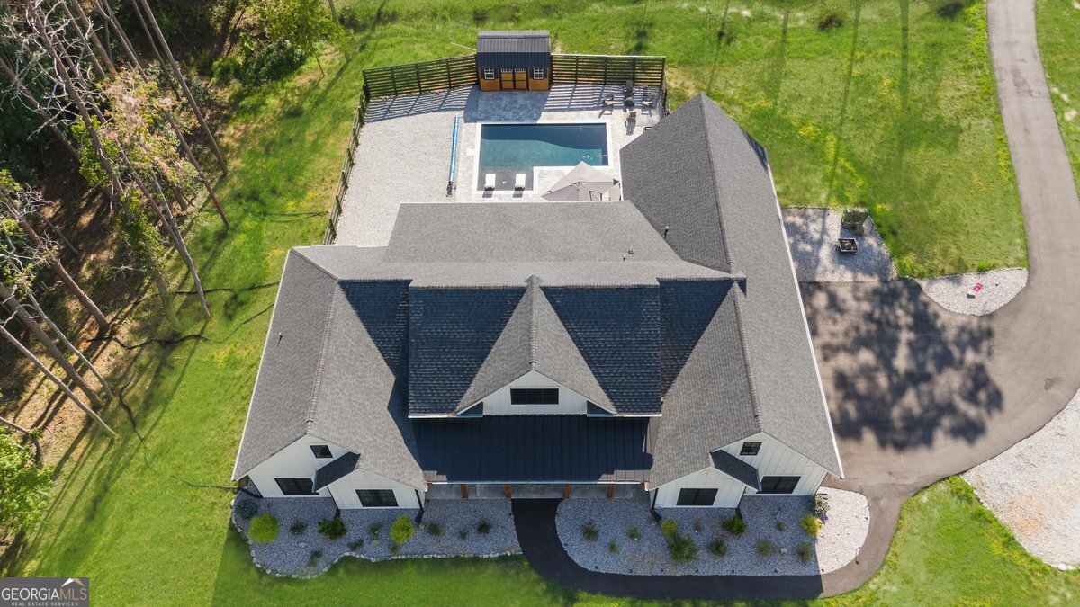 Welcome to 37 Pigeon Creek Drive. A true one-of-a-kind custom-built ranch home, with an upgrade list that goes for miles! Hard to find 5 bedroom & 3.5-bathroom ranch with over 4k sq.ft. of living space to enjoy. Sitting on 2.26 +/- private acres. As you walk up to the home you are welcome by the oversized covered front porch with double door entry. As you enter the home, you enter into the oversized entry foyer, with private den/office to the right with barndoors, and the formal dining room to the left. As you flow back into the home, you enter the open concept area with family room with bookcases, fireplace, beams, custom lighting and views to the backyard. The eat- in kitchen is stunning with Forno appliances, a custom walk-in pantry with wood shelving, an overside island, custom cabinets & level 4 custom granite. This home is a split floorplan. The left side of the home features the primary bedroom with fireplace, and custom bathroom with custom closet, as well as a guest 1/2 bath and a large laundry room and mud room area. There is also access to the bonus bedroom upstairs currently used as a home office with 2 walk-in closets. You also have access to the 3-car side entry garage. The left side of the home features 3 bedrooms, one with a private bathroom, and one currently used as a media room with custom doors to give access to the backyard! This room makes a great indoor/outdoor space to your outdoor living. Hall bath with double vanity also on the left of the home. There is a beautiful sunroom off the kitchen with new custom aluminum clad windows. This gives access to the covered back patio that leads out to your new in-ground heated saltwater pool with tanning ledge. Additional storage outback in the new shed, and tons of privacy with a custom wood fence in the backyard. All closets in the home are custom wood. There is a built in stereo system that services the family room and dining room. All new floors just installed, driveway just asphalted, new custom lighting, new garage doors. the home is serviced by a 6-ton split system on the main and a new 2.5 ton for upstairs. Tankless water heater, 330 gallon buried propane tank. The pool is app controlled with many features. All gutters have the leaf guard system. The home has the whole home Pest ban system. The windows have been tinted on the home. Gas fireplaces in the family room and primary bedroom. This is a true one-of-a-kind home, that you have to see in person to appreciate. There are so many upgrades and custom features to list about this home. Call today to learn more and book your private tour!