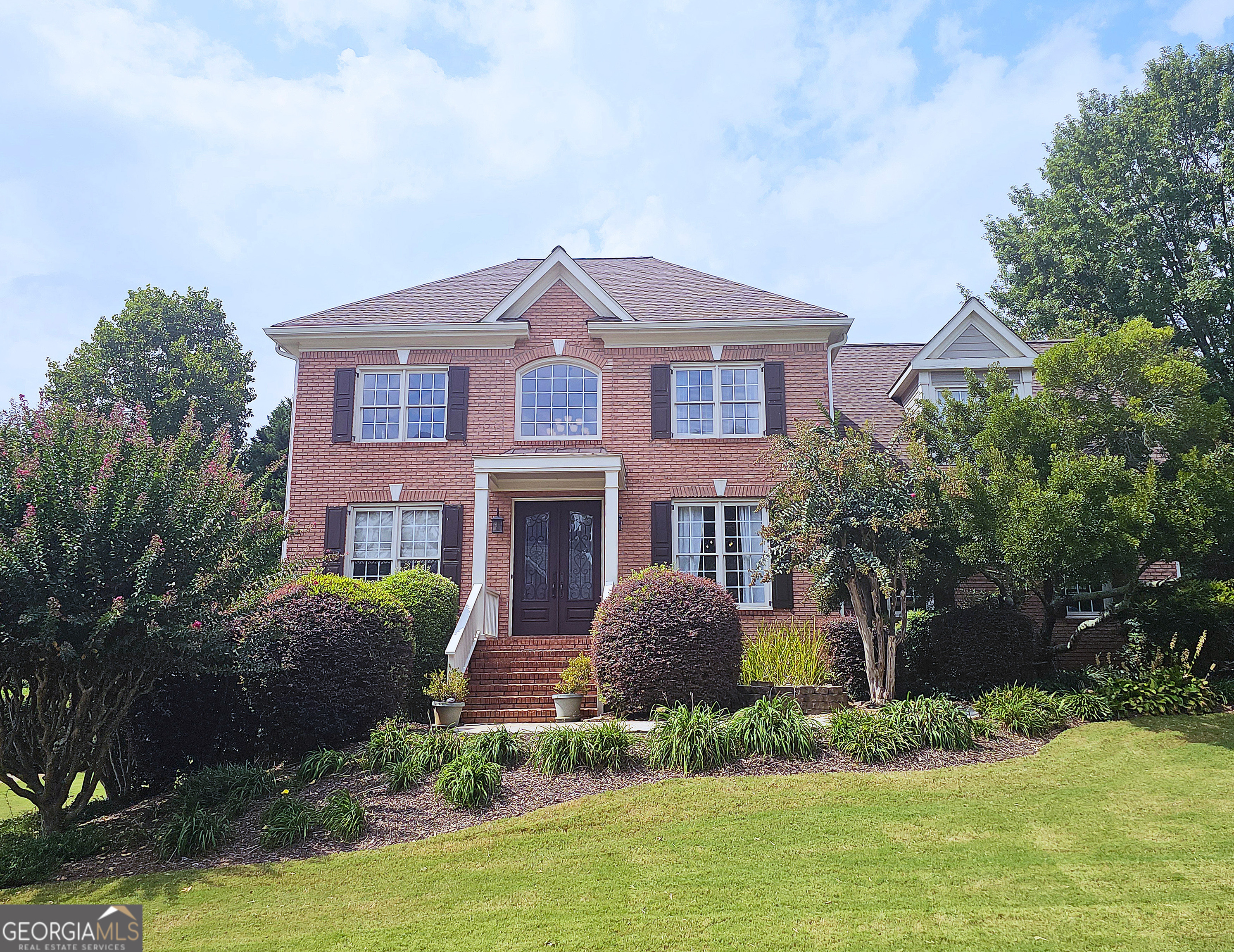 Welcome to this stunning home in the highly sought-after The Downs subdivision, where elegance, comfort, and functionality come together beautifully. Step into the impressive two-story foyer that opens to a formal living room and dining room-ideal for entertaining or hosting special occasions. The spacious family room, featuring a charming brick fireplace with gas logs, flows seamlessly into the updated kitchen. With modern finishes, solid surface counters, stainless steel appliances, and an oversized eating area overlooking the garden trellis and deck, this kitchen is the true heart of the home. Expansive windows fill each room with natural light, while hardwood floors on the main level and brand-new carpet upstairs add warmth and style. The oversized primary suite offers a private retreat with a spa-like bath, including dual vanities, a whirlpool tub, and a separate walk-in shower and large walk in closet. Upstairs, you'll find three additional generously sized bedrooms-one with a vaulted ceiling and walk-in closet-plus a convenient Jack-and-Jill bath. The full daylight basement includes a finished area with a full bath, plus abundant storage space. Outdoors, a beautifully designed deck with trellis creates the perfect backdrop for dining, entertaining, or simply enjoying peaceful evenings in the private fenced yard. Living in The Downs means access to premier amenities, including a community pool, tennis courts, and a picturesque lake with dock. The neighborhood's location offers easy access to excellent schools, shopping, dining, and more. With its thoughtful layout, stylish updates, and unbeatable community, this home is a must-see!