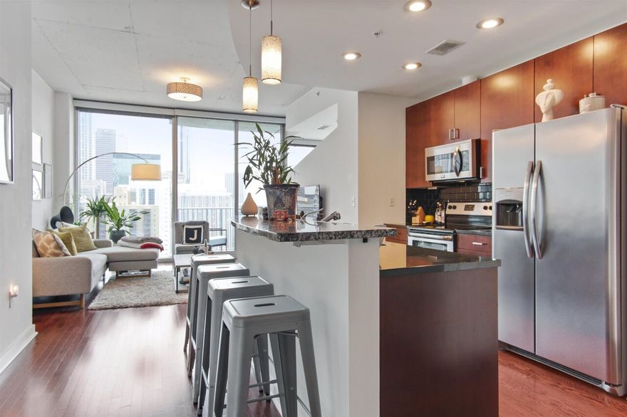 Spectacular South view of downtown and East/West views that you can enjoy from your own private balcony, an incredible location and renovated amenities make this a perfect place to call home; gorgeous hardwood floors in main living area with an open concept that allow for easy entertaining; Primary bedroom has those spectacular views, off of the primary bedroom is your custom closet with laundry and spacious bath with a private entrance for guests; home also has a deeded storage unit and parking spot.