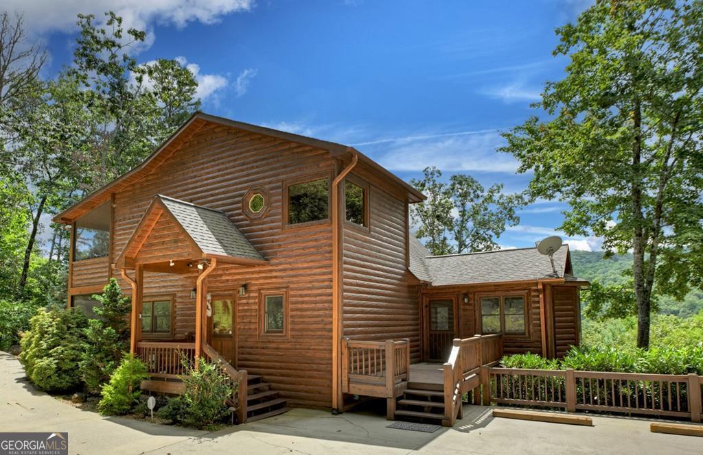 WOW FACTOR RIGHT IN THE HEART OF THE ASKA ADVENTURE AREA!! This immaculately maintained 4 bedroom, 4 bath mountain ESTATE offers convenience to downtown Blue Ridge on all paved roads and underground utilities. The MAIN HOUSE boasts of spacious main-floor living area and wall-of-windows showcasing the year-round panoramic mountain views, gourmet kitchen w/custom cabinetry, separate dining area, rough sewn timber and barn wood accents, custom tiled bathrooms, main level screened in porch w/outdoor fireplace, finished basement w/recreation room and gas-log fireplace. The GUEST HOUSE/2-car garage offers an additional bedroom, full-bath, full kitchen and living area w/stacked stone fireplace, outdoor living space, 2-car oversized garage w/ample driveway parking. Located in a cul-de-sac and just minutes to the Toccoa River, USFS for hiking/mountain biking and Lake Blue Ridge for all outdoor amenities. Whether you are looking for a second home or an investment property with rental potential, this one is ready for you to call your home away from home!