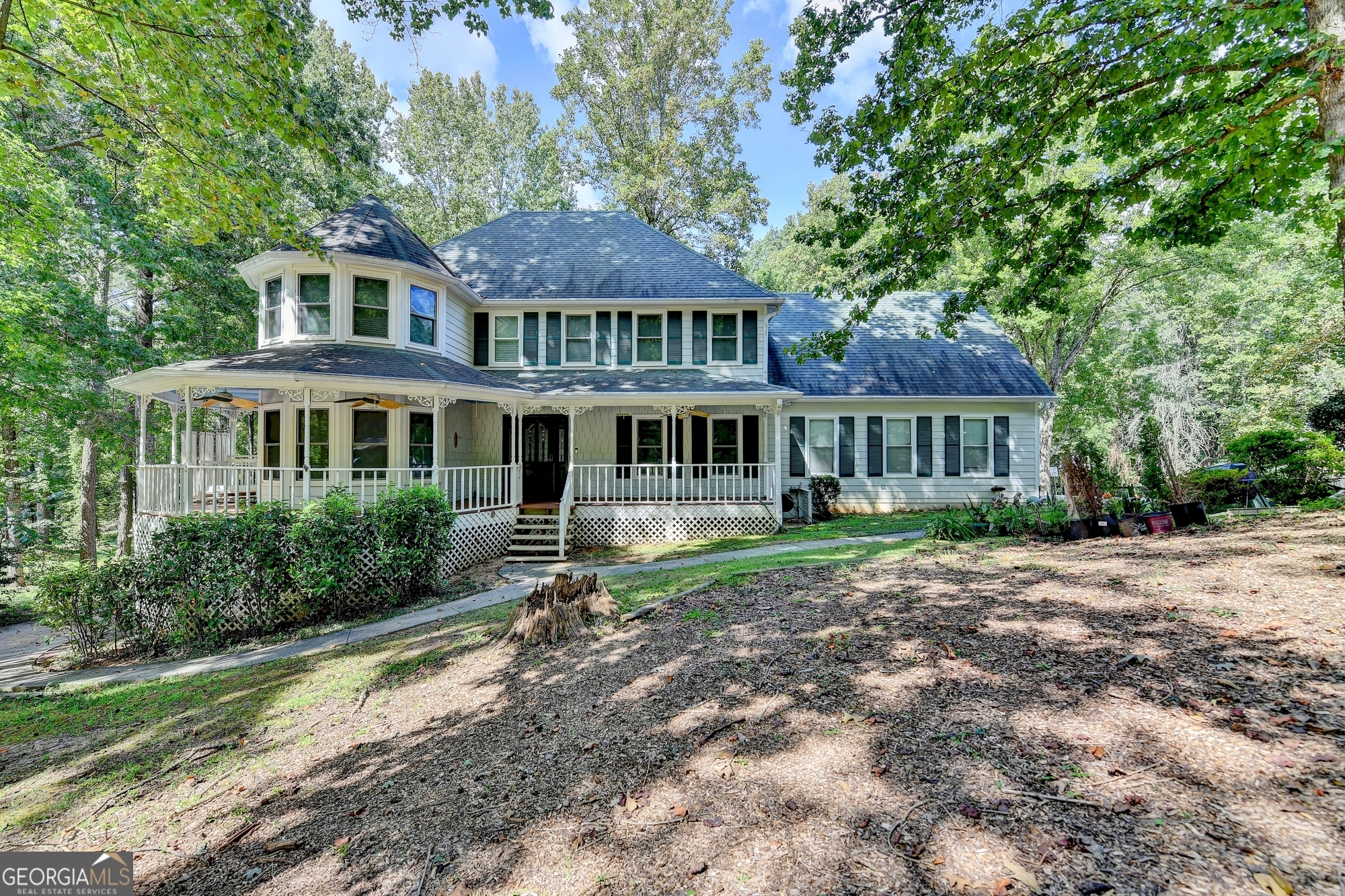 Welcome to 402 W Leslie Court - a standout Victorian-style home tucked into a quiet corner lot in the heart of Woodstock. From the moment you arrive, the inviting wraparound front porch sets the tone for what's inside: space, charm, and serious lifestyle appeal. Inside, you'll find 3 spacious bedrooms, 2.5 baths, and a bright, open layout made for modern living. The kitchen boasts stainless steel appliances, updated counters, and opens effortlessly to the dining and living areas - perfect for hosting or everyday hangouts. A cozy fireplace and views of the private backyard complete the main living space. Upstairs, the oversized primary suite is a true retreat, complete with walk-in closet, double vanity, and a bonus room ideal for an office, nursery, or media space - with its own private staircase. The partially finished basement offers even more flexibility, with space for a home gym, workshop, or rec room, plus extra garage/storage space. Outside, enjoy a massive flat backyard with direct private lake access - a rare feature in this community. A fully wired detached "she-shed" adds even more versatility for a studio, home office, or retreat. Garden space, mature trees, and a spacious deck make the outdoor areas just as livable as the inside. This is more than a home - it's a lifestyle. Schedule your showing today and discover everything this unique property has to offer!