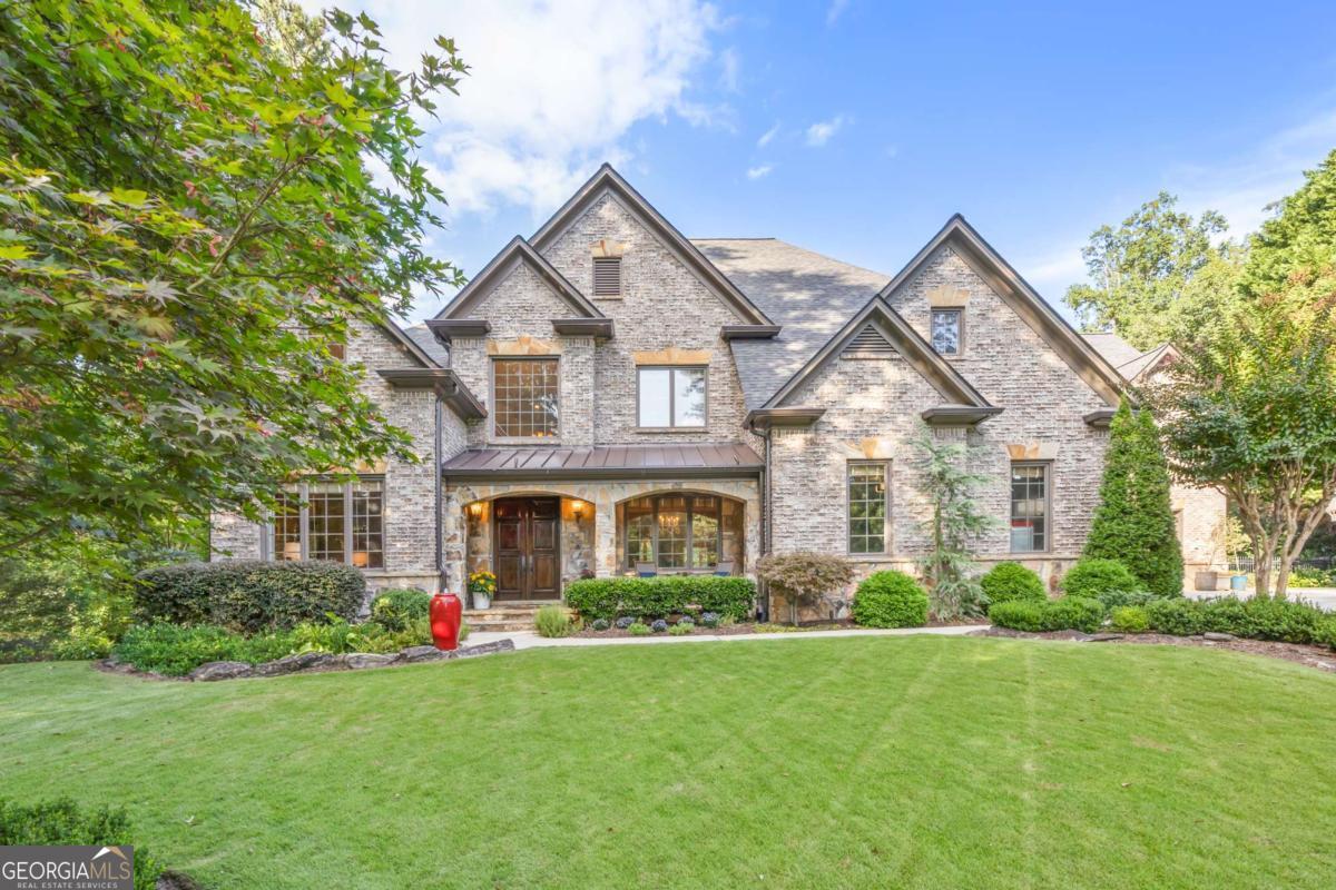 Welcome to 1629 Heatherwood Drive, located at the top of a hill in one of Decatur's most desirable neighborhoods. Built in 2003, this beautifully maintained home offers nearly 8,000 square feet of thoughtfully designed living space that blends modern design with luxurious comfort. This seven-bedroom, seven and-a-half-bath residence features soaring ceilings. The inviting front entrance includes a cozy seating area, leading into a sophisticated foyer that seamlessly connects to spacious living and dining areas. Upstairs, four additional bedrooms provide comfort and flexibility. Outside, enjoy a spacious backyard complete with a fire pit and dedicated seating area perfect for gatherings or peaceful evenings at home. The oversized primary suite, located on the second floor, includes a sitting area, a private balcony overlooking the backyard, a spa-like bathroom, and a large walk-in closet. The chef's kitchen is a true highlight, featuring a walk-in pantry and an adjacent TV room, ideal for entertaining. Also on the main level, you'll find a sunroom and access to a back deck perfect for outdoor relaxation. Close to top schools and daily conveniences, this exceptional property offers a rare opportunity to create your dream home in a highly sought-after location.
