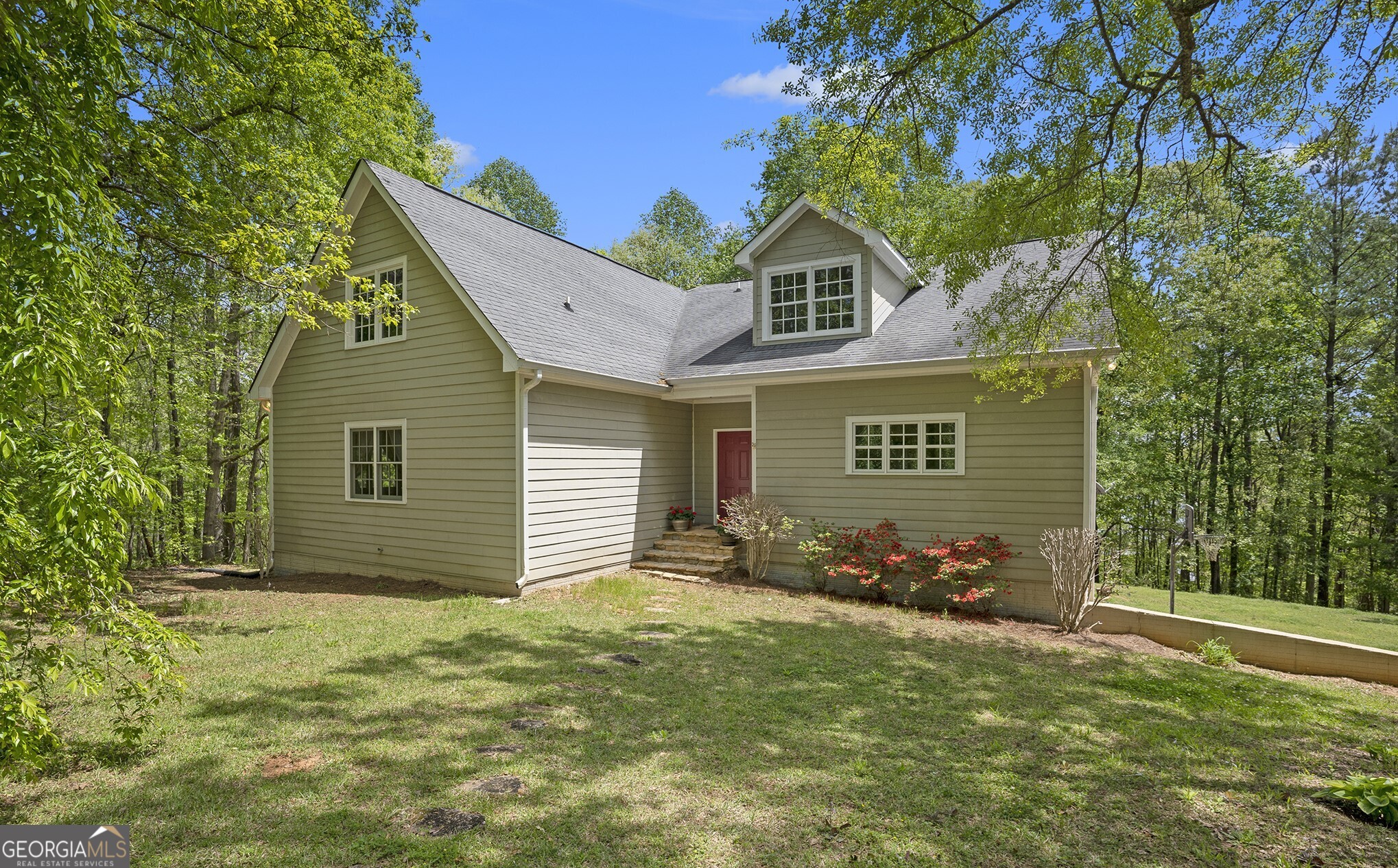 Experience peaceful, easy living in this beautiful custom home which backs up to a quiet lake cove. A warm, inviting space that delivers the perfect gathering place for family holidays in tranquil surroundings. A generous deck runs the length of the back of the house providing breathtaking seasonal views of West Point Lake and a smaller screen porch is the perfect spot for al fresco dinners. Relax in this refuge from the city which offers exceptionally large bedrooms, all with views of the surrounding woods. The heart of the home is a spacious kitchen, designed for both practicality and entertaining. The property also features an enormous walk-up attic, fully plumbed and with HVAC, for future customization and providing ample storage as well. In addition, a partially finished basement offers even more potential for personalized living space. Don't miss out on this remarkable opportunity to embrace country living on West Point Lake with easy access to recreational activities via a nearby public boat ramp. This versatile home with its custom floor plan is waiting for you to make it your own!