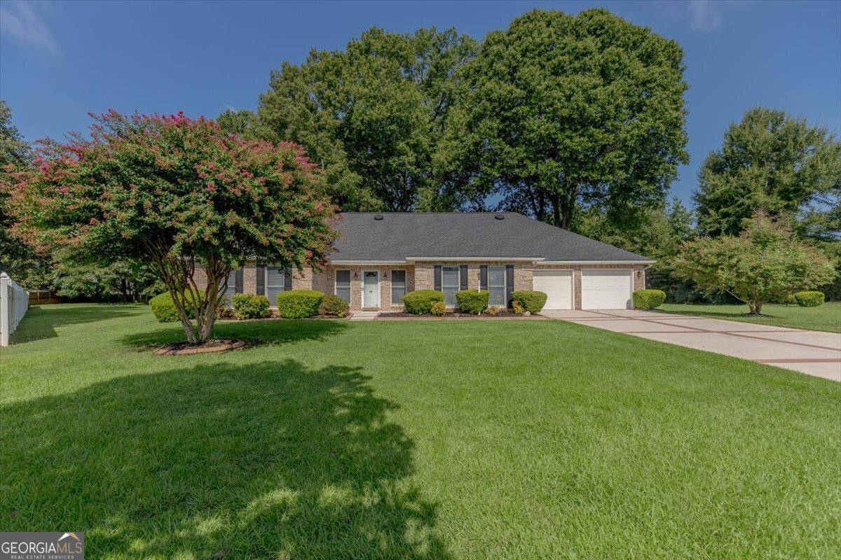 *SELLER REQUESTS NO SHOWINGS AT THIS TIME* FULL BRICK BEAUTY ON 2.71 ACRES- PRIVATE CUL-DE-SAC LOT INEXCETLLENT SCHOOL DISTRICTZONED FOR COUNTY TAXES ONLY& NO HOA! Tucked away at the end of a quiet cul-de-sac, this full brick home sits on a beautifully shaded 2.71-acrelot offering privacy, peace, and room to roam - all with county taxes only and no HOA. The property boasts a 5-year-old roof, 2-car garage, a workshop, two storage buildings, and an additional carport perfect for storing your boat, camper/RV, ATV, or extra vehicles. An underground fence is already in place so pets can enjoy the entire yard. Step inside to find FRESH PAINT throughout, wood laminate floors in the great room and bedrooms, and an oversized great room featuring a gas fireplace with a stunning brick hearth and surround that extends from floor to ceiling and step through the French Doors for easy access to the Heated & Cooled Sunroom. A large formal dining room is perfect for gatherings, while the kitchen offers abundant cabinetry, solid-surface countertops, and a spacious breakfast area with two double windows for plenty of natural light. The split bedroom floor plan includes a generously sized primary suite with private access to the sunroom. The primary bath features a dual vanity, oversized custom tile shower, and walk-in closet. Guest bedrooms are spacious and share easy access to a large guest bath. Additional highlights include tile flooring in kitchen and baths, a tankless water heater, and a separate laundry room with cabinets, shelving, and counterspace for additional storage. This property blends the charm of country living with modern conveniences, all in an excellent school district and minutes from shopping, dining, entertainment, I-75 and more.