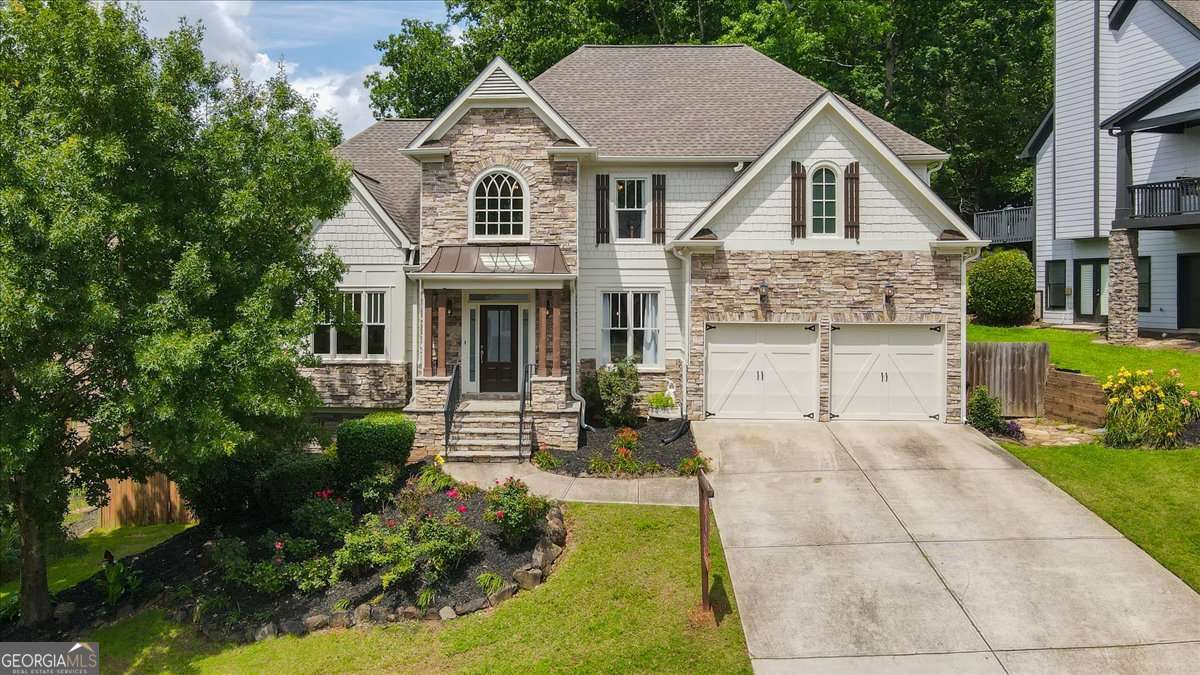 Nestled in a picturesque country backdrop of Dallas Georgia is the lovely Reserve At Timberlands neighborhood, and this home will amaze. Wake up to coffee on the oversize back patio overlooking the natural beauty and wildlife of your private retreat before you and yours take the short walk to the pool, tennis courts and yes! brand new pickleball courts. Weekends will be enjoyed with family and friends in the massive game day basement equipped with a pool table, and areas for his and her hobbies plus endless storage. The Chef's kitchen and large great room are perfect for holidays and large gatherings. Nothing was overlooked in the layout of this home with the guest bedrooms on the main, a second story with three bedrooms, and beautifully renovated master bath and jack and jill bath. This lovely home has been refreshed with light fixtures throughout and new paint inside and out, giving it that modern country feel. Hard wood floors throughout, and a new water heater, this house is well maintained and move in ready. Come live in one of the most desirable areas in Northern Atlanta with excellent access to lakes, hiking and biking and so much more.