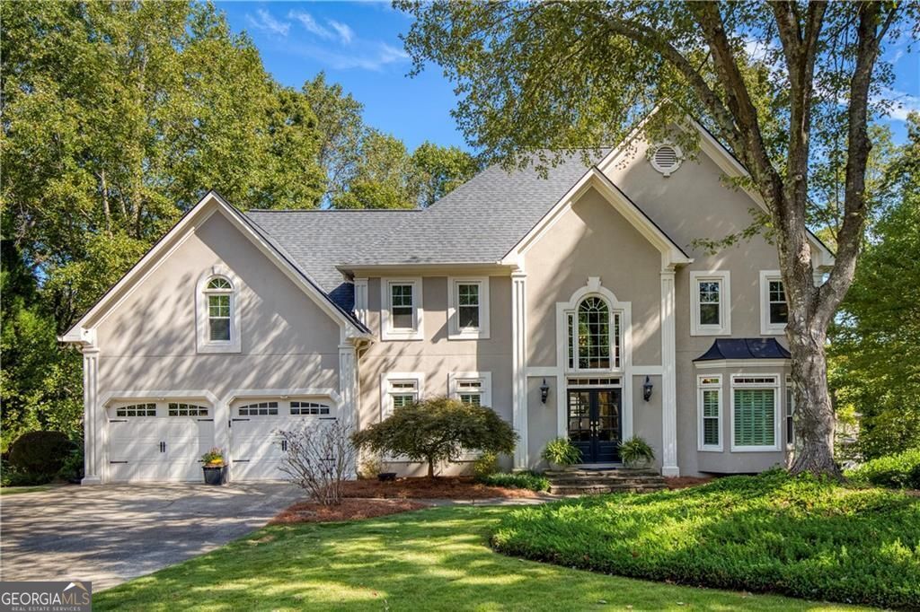 Welcome to this beautifully updated residence in the highly sought-after Wildwood Springs community. Enter through the expansive two-story foyer, where abundant natural light and refined details set the tone for the elegance found throughout this home. Every element has been thoughtfully curated to blend timeless style with modern comfort. The renovated chef's kitchen features quartz countertops, stainless steel appliances, custom cabinetry, and a stylish island that opens to the fireside keeping room, creating a warm and inviting space for everyday living and entertaining. The luxurious primary suite is a serene retreat offering a spa-inspired bath with a soaking tub, frameless glass shower, dual vanities, and custom-designed closets for elevated organization and comfort. The finished terrace level is an entertainer's dream - complete with a custom bar, home theater, fitness studio, guest bedroom, and full bath. Perfect for movie nights, workouts, or weekend guests. Outdoor living shines with a screened porch, deck, and firepit area surrounded by lush landscaping - ideal for year-round relaxation and gatherings under the stars. Situated in one of Roswell's most desirable neighborhoods, offering resort-style amenities, top-rated schools, and convenient access to historic downtown Roswell, parks, shops and restaurants - this home truly has it all.