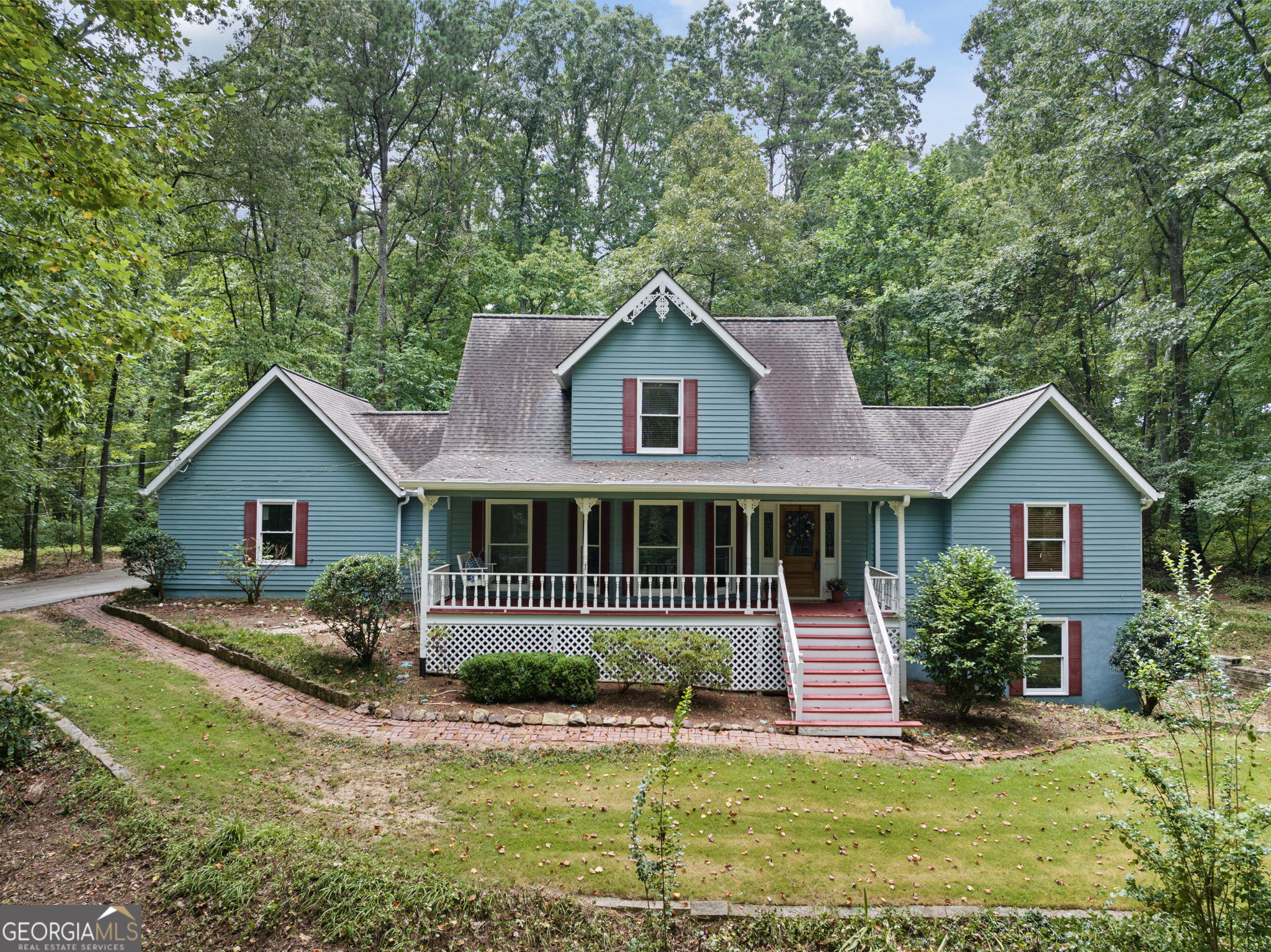 Custom Home on 4.5 Wooded Acres - Minutes from I-20, Shopping & Dining! This beautiful custom-built home is nestled on 4.5 wooded acres and boasts fresh interior paint, new carpet, and stunning reclaimed hardwood floors. Enjoy relaxing mornings and peaceful evenings on the charming rocking chair front porch, complete with a porch swing and a custom leaded glass front door entry. Inside, you'll find open-concept living and dining areas with rich, character-filled hardwoods that set a warm and inviting tone. The chef's kitchen is a standout with custom cabinetry, double ovens, a cooktop, and a built-in desk-perfect for meal prep or working from home. It opens seamlessly into the expansive great room, featuring soaring vaulted ceilings that make the space ideal for entertaining or cozy nights in. The primary suite is conveniently located on the main level and offers new carpet, a luxurious soaker tub, separate shower, and a massive walk-in closet. A stylish half bath with a custom vanity and a spacious laundry room with a utility sink complete the main floor. Upstairs, you'll find two oversized secondary bedrooms-each with generous closets-and a well-appointed secondary bathroom. Need more space? The massive unfinished basement includes a boat door and endless possibilities for storage, workshop, or future expansion. Welcome Home!