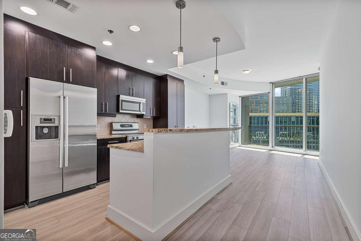 Your sun drenched one bedroom with great views in 1010 Midtown awaits! This 10th floor unit looks directly down Peachtree St and includes a rare storage room and premium parking space. Complete with floor to ceiling windows which bring the outside in, this unit feels spacious and bright. The kitchen opens to the living space and stainless appliances, granite counters, and stained cabinets with great storage. 1010 Midtown offers some of the best amenities with a south facing pool deck, clubrooms for your enjoyment, and large fitness rooms. Perfectly located in Midtown and walking distance to Piedmont Park, MARTA, the Beltline, Colony Square, and more!