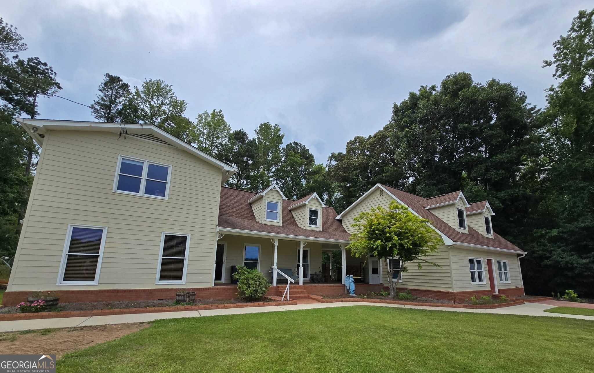 Professional photos coming Wednesday 7/23 check back. Home has additional acreage just acquired and not part of tax record yet for a total 3.63 acres. The main area of the home is 1,867 sq ft, it is a 3/2.5 with master on the main, upstairs is 2 bedrooms with a shared bathroom. The living room features a wood burning stove with beautiful stone features. Barn doors separate the living room from an enclosed sun porch. Off the sun porch is a small barbecuing deck which is also accessible from the kitchen. The 1,867 sq. footage does not include the additions. The addition to the right is a 1/1 with kitchen hook-ups, full bathroom and laundry room, it also can be easily converted to stepless entry. Around back of the addition go upstairs and you'll find a studio apt. with a full bath, kitchen and laundry. Let's talk about the garage building which is in excellent shape and constructed in 2009. The building has four bays with fours rolling doors, one back rolling door as well as a side entry door. Great for a cross breeze. Building also has a concrete floor, heat and water, plus plumbing that is tied into the septic system. Right now that building is storing a 24' pontoon boat and a duly RV. It's very big, 2400 sq ft BIG. Also there is an additional covered outdoor work area behind the building. This property is zoned agricultural so if you want to put a some livestock, you can. Property is in Douglasville stones throw to the Paulding line. 2020 taxes before homestead exemption and with only 1 ac were $1,977. These taxes will go up due to additional acreage. Septic redone 3/2025. Bonus, there is also a small building on the property with a concrete floor. This home does not qualify because of location for USDA financing but down payment assistance is available. Home comes with a home warranty and seller may be willing to assist with some closing cost with the right offer. Owner occupied, showings daily by appointment.