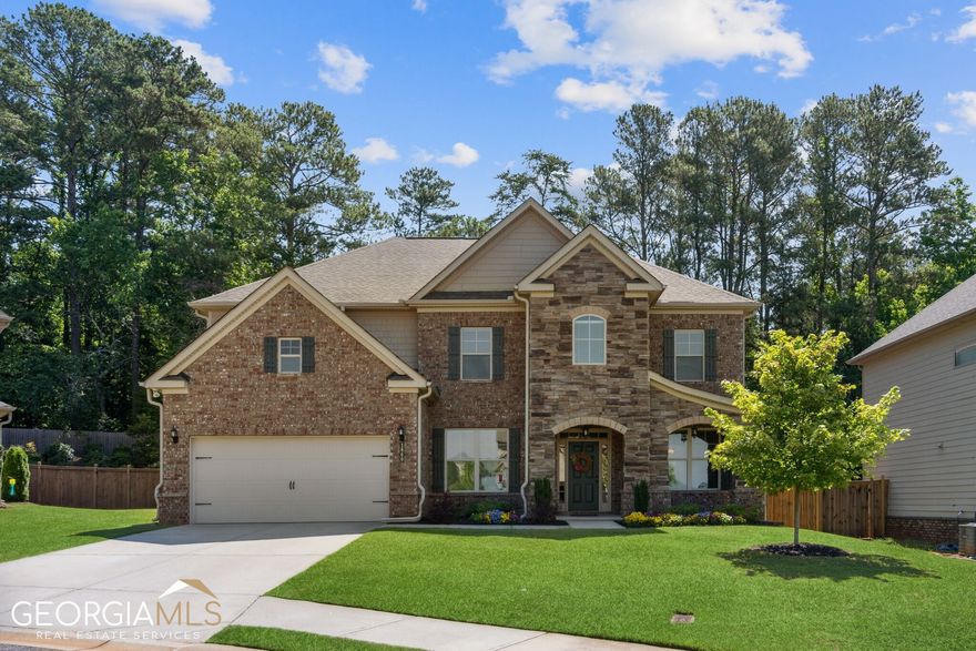 Seller received a great, new job offer and his happy circumstance can now be your buyer's good luck too!  Home feels almost new and is filled with many of the most popular builder upgrades.  Featuring numerous upgraded architectural details - including a mixture of stacked stone and brick (front PLUS a 4-sides brick water table) this property is beautifully situated on a cul-de-sac in a sought-after community which offers GREAT SCHOOLS!  As you enter, you will be captivated by the view of the lush, private backyard through the wide expanse of windows in the family room beyond - but, be sure to take a moment to appreciate the formal living/office and dining spaces on the way.   The bright, open concept kitchen offers a huge island and breakfast area overlooking a spacious family room w/ fireplace.  Kitchen features stainless steel appliances DOUBLE OVENS, creamy WHITE PAINTED CABINETS and an on-trend tile backsplash.  Main floor offers a roomy dining room and office/living room (perfect for working at home) as well as a guest bedroom w/ adjacent full bath tucked away for privacy. Upstairs you will find an oversized owners' suite, a spacious PLAYROOM/MEDIA ROOM and three additional bedrooms (1 with a private bath and 2 sharing a Jack & Jill)   All bathrooms feature tile floors and shower surrounds.  A private COVERED PATIO offers the perfect spot for BBQing with friends or quiet family dinners, no matter what the weather.  Level driveway and fenced back yard.  With its beautiful, mid-tone hardwoods, neutral carpeting and fresh, on-trend interior paint colors, this home offers a buyer an amazing value.   Forsyth Central (STEM).  So close to Kelly Mill Elementary you could almost walk!  Close to 400 Hwy, Shopping & Dining.   Swim Community with connected entrance to Big Creek Greenway trail. This is a must see!
