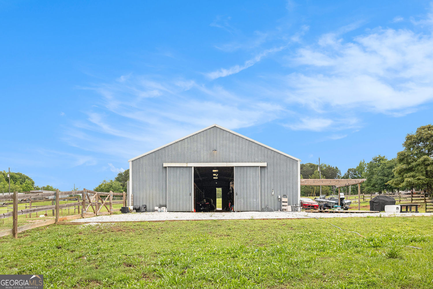 Equestrian Dream on 12.8 acres, Versatile Barn with one bed, one bath with kitchen, Horse Ring & More! Welcome to your private countryside retreat, just minutes from I-85 and only 10 minutes from the Tanger Outlets! This 12-acre property is a haven for horse lovers, farmers, or anyone seeking space, peace, and opportunity. The centerpiece is a large barn featuring 7 stables with ample storage, a dedicated shower station, and endless versatility. Whether you're boarding horses, training, or envisioning a recreational with residential one bed one bath. Enjoy the horse ring, which is ideal for equestrian training. The land is thoughtfully laid out and can be divided into a 10-acre parcel and two 1-acre lots, giving you even more flexibility for development or investment. Plus, there's room to bring your trailer home or RV, making it perfect for a live-work lifestyle in nature, without sacrificing access to nearby amenities. Bring your vision, your horses, and your dreams-this property is ready for you!