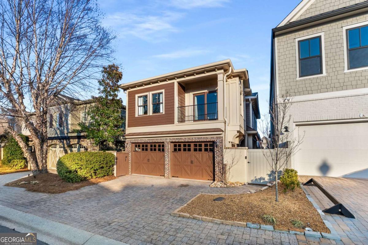 Welcome to this beautiful European Craftsman in the sought after community, The Village at Towne Lake! Exceptional design elements feature throughout the high-quality built property. You're welcomed into the home with an exquisite living room featuring a floor to ceiling double-sided fireplace, custom built-in's and an abundance of natural light. The open concept kitchen overlooks a lovely dining room that leads directly through French doors to the professionally landscaped outdoor courtyard, a perfect arrangement to entertain. A convenient half bathroom leads upstairs where you are greeted with an array of custom built-ins and a very convenient bonus workspace. The large primary bedroom is paired with a stunning ensuite bathroom, including walls of travertine tile, a double vanity with stone counters, a jetted tub, and a custom tiled walk-in shower. Across the hall features a full bathroom with double vanity and tiled shower, and two additional bedrooms, one includes a private balcony overlooking the community! Roof, WH, and HVAC are all recently replaced and the home is newly painted inside and out! The Village at Towne Lake is a gated subdivision with first class amenities, including a pool, tennis and bocce ball courts, and numerous pet parks. Located a few minutes to Downtown Woodstock, this home presents the opportunity to live a wonderful lifestyle near all the restaurants, shops and nightlife! It's yours for the taking.