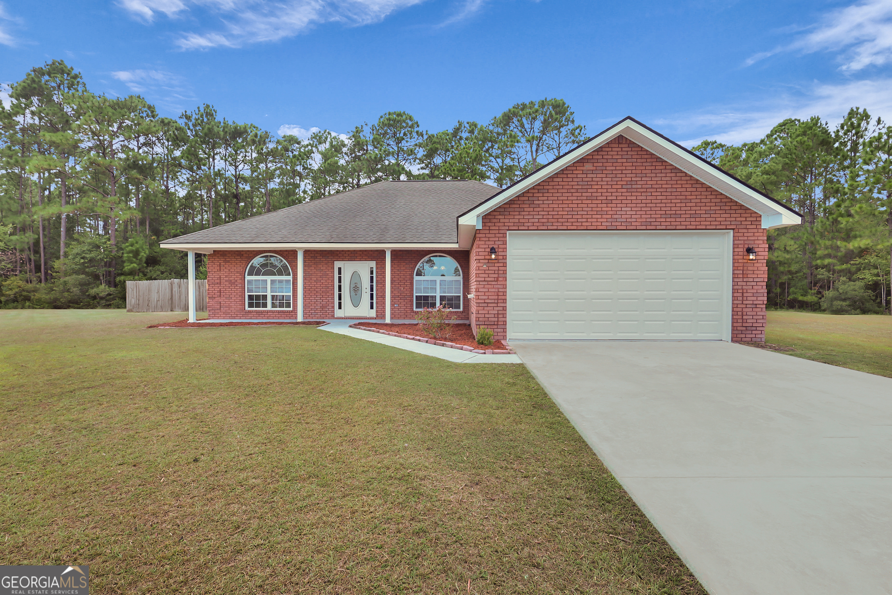 New on the market! This all-brick ranch home comes with $8,000 toward the buyer's closing costs and the freedom of NO HOA - a rare find you don't want to let get away! Tucked away on a quiet cul-de-sac at 95 Shelby Rae Road NE in Ludowici, this 4-bedroom, 2.5-bathroom home offers 2,178 sq ft of living space on a spacious 0.71-acre lot. Inside, you'll find fresh paint throughout and no carpet, with tile and luxury vinyl plank flooring for easy maintenance. The vaulted ceiling in the living room, complete with a cozy fireplace, creates a warm and inviting atmosphere, while the tray ceiling in the owner's suite adds an elegant touch. The split-bedroom plan provides privacy, and the layout includes a formal dining room as well as an eat-in kitchen with a cooktop and double oven. Outside, enjoy a fenced backyard perfect for entertaining and a double-car garage.