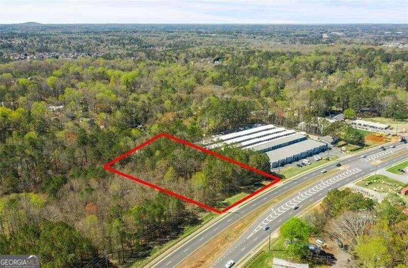 DEVELOPMENT OPPORTUNITY: Parcel ID 21N12 182 is located on Highway 92 in Acworth, GA, in Cherokee County. The almost two-acre raw land has utility connection located directly in front of the property. This site is ideal for commercial or retail development with nearly 200 feet of road frontage and a high traffic count of 39,600+/- vehicles per 2023 estimates. It sits adjacent to Midgard Self Storage at 5534 Hwy 92, Acworth, GA, midway between I-75 and I-575 - less than 5 miles in either direction. While the property is currently zoned as SFR (Single-Family Residential), the surrounding area along Highway 92 is undergoing a transition from residential to commercial use. Proximate is a new 330-unit luxury apartment and 600 single-family home development less than one mile away. Within 5 miles is essential shopping like Kroger, Target, Kohl's, Lowe's, Home Depot, Chick-fil-A, and Sam's Club. The property has two driveways and a level topography. Imagine the possibilities and join the growth alongside neighboring businesses.
