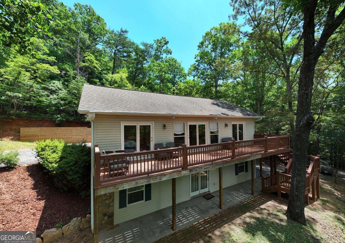Nestled in the heart of the N.E. Georgia mountains, this beautifully fully furnished, updated 2 bedroom 2 bath home offers comfort, privacy, and stunning views of Brasstown Bald in the winter time. Set on 2.29 acres of unrestricted land, this property is perfect for full-time living, a vacation getaway, or short term rental potential. Inside, enjoy the warmth of a stone fireplace, gorgeous wood floors, and fresh new carpet. The spacious kitchen features 1 year old appliances, while the entire home benefits from a new HVAC system and a whole-house dehumidifier for year-round comfort, Step out onto the large deck to take in the mountain air. The unfinished basement provides endless potential, finish it to suit your needs or use it as a workshop or storage. The HVAC is set up to change thermostat to control both upper and lower levels separately. The basement garage offers convenience and additional space. Recent updates include new concrete driveway, new fencing, retaining wall with enhanced drainage, refreshed landscaping for enhanced curb appeal. This property offers privacy, natural beauty, all without the restrictions of an HOA. Just a short drive to local hiking, Lake Chatuge, and charming mountain towns. Don't miss this opportunity to own a slice of mountain paradise.