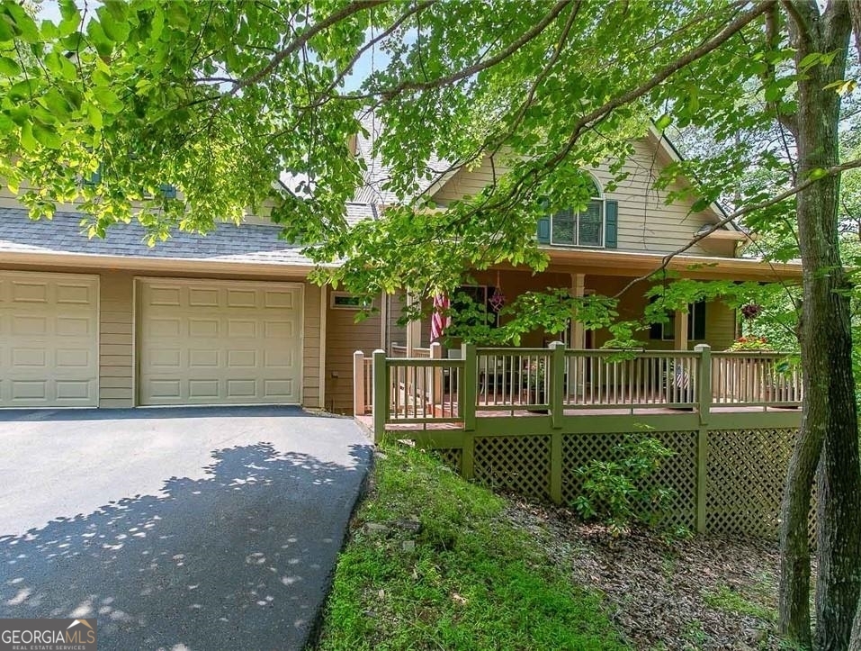 Greet your friends and sit a while on the rocking chair front porch of this stunner in the sought-after gated community of Big Canoe! Amenities Galore- Boating, Golf, Clubhouse, Lake, Playground, Swimming, Tennis, Fitness Center, Walking Trails, Park, Meeting Room, Clubhouse. Inside will not disappoint! Plenty of natural light throughout the home's airy layout. An incredible open layout is great for entertaining. The impressive two-story fireside family room is graced with an open view of the kitchen and a gorgeous expanse of windows along the back bringing the outdoors inside. Enjoy peaceful crisp air mornings on the screened-in porch looking out at the gorgeous wooded views! . The gourmet white kitchen will inspire your inner chef- complete with a breakfast bar, SS appliances, stone counters. An oversized master retreat on the main to envy with a luxurious spa bath featuring dual vanities, a separate shower, and a soaking tub. Two ample-sized secondary bedrooms on the upper level provide privacy for guests or plenty of room for family sleep and play. The entertainer's delight in the finished basement is great for rainy day play. Large grilling deck for those family gatherings. Move in today and start making memories tomorrow!