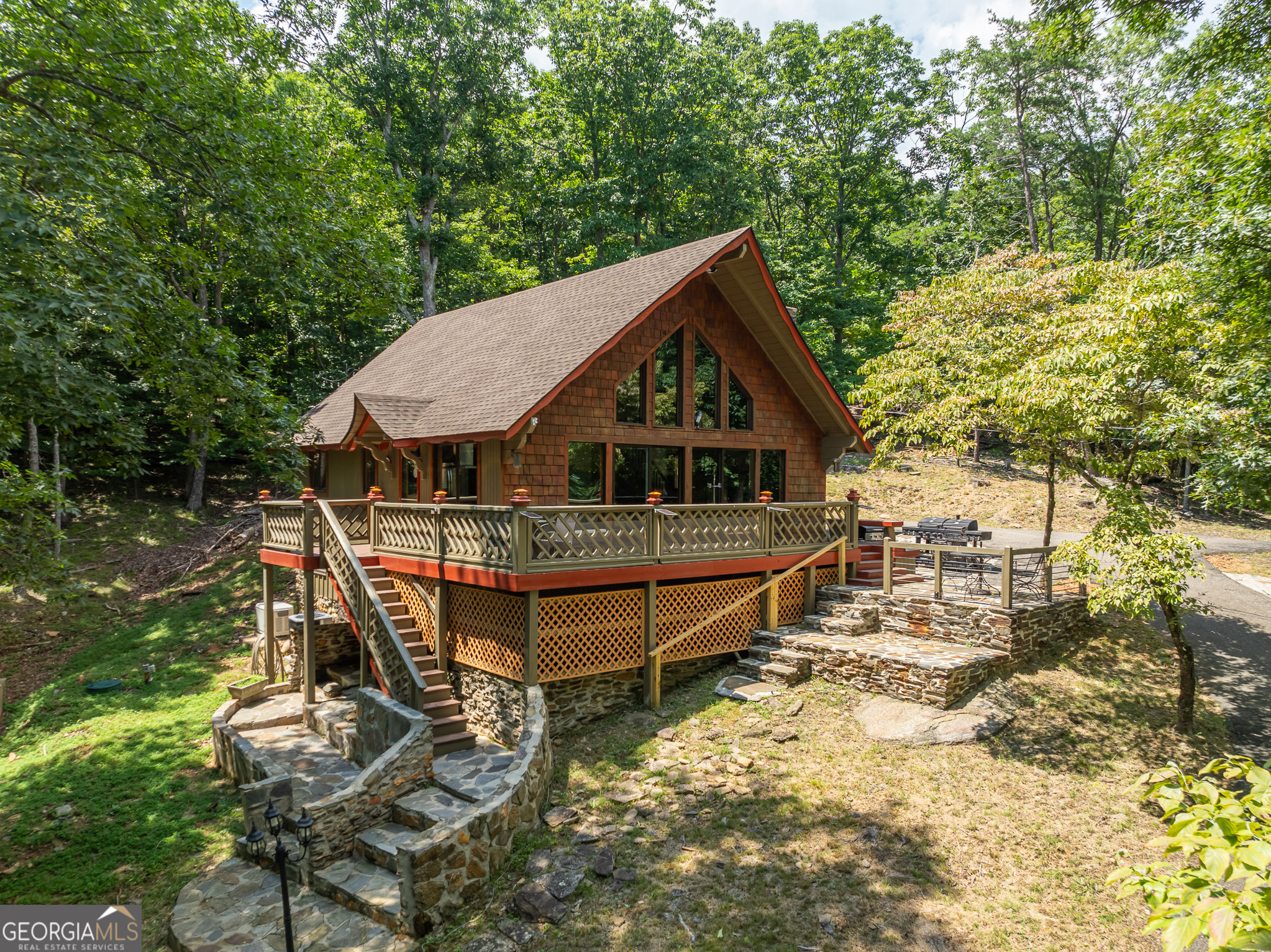 Welcome home to 771 Little Hendricks Mountain Rd! Up the paved driveway, you will feel invited to unwind and enjoy the serene surroundings and might even get a chance to meet Goldilocks and the three bears! This home is a quaint wooden shingled rustic style Chalet, located within the sought after community of Bent Tree. Home is adorned with stacked stone and flagstone paved walkways. Enjoy the fresh mountain air and long weekends in the hot tub, or on several stone paved outdoor seating areas wrap around porch a including a screened-in porch, and a wrap-around porch. Here you will be nestled in a private lot with mountain views, just over an acre with lots of room for entertainment or just listening to the birds. Cuddle up to a cozy fire on a crisp autumn night outside with the firepit or inside snuggled in front of the floor to ceiling stacked stone, wood burning fireplace. As you step inside you are greeted by the floor to ceiling windows and sliding doors allowing lots of natural light. Enjoy the open concept style of living, dining and kitchen space. The kitchen is fully functionable with lots of cabinets for dishes and extra appliances. Stainless steel appliances, granite countertops, and a gas stove. You will find warm, hardwood flooring throughout. Vaulted ceilings with exposed beams and upper wooden panels enhance a spacious feel to this charming abode. Other upgraded features are beautiful ship lap ceilings in some of the bedrooms and wooden barn-doors. The 3-bedroom, 2 full bath home is ready to move into as a full-time residence or can be used as a short-term rental, long term rental or a weekend vacation home. Two bedrooms are on the main floor with an additional bedroom upstairs. Both bathrooms are updated including a large, tiled shower and upstairs you have a Clawfoot soaking tub! Recent home improvements are a newly replaced roof and a completely new septic system. Outdoor enthusiasts and active individuals will love the gated golf cart community. Bent Tree boasts a plethora of resort style amenities including the 110 Acre Lake for Swimming, Fishing, Kayaking, and Boating. The Joe Lee Designed 18 Hole Golf Course and clubhouse and restaurant, 2 swimming pools, an Equestrian center with trail rides, hiking trails, indoor and outdoor tennis and pickleball courts, and of course a dog park for your furry companions. Bent tree even has a private Fire Department. You will also have access to some of the best health care from several nearby hospitals, be able to enjoy local Wineries, Breweries, Restaurants and shopping.