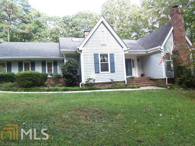 This unique ranch is ideal for anyone who appreciates nature, privacy and tranquility; it sits on just under 2 acres but requires limited yard maintenance and offers a split bedroom plan, wide plank wood floors, oversized dining room, vaulted great room with exposed wood beams & masonry fireplace. The sunroom connects to kitchen & overlooks deck/pool; secondary bedroom with fireplace could be office/den. Basement w/boat door great for storage. No HOA fees!