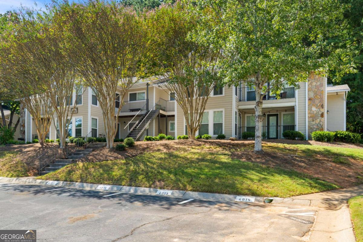 Have you been waiting for an affordable condo that offers both privacy and unbeatable convenience? Well, your patience has paid off! Welcome to this spacious 2-bedroom, 2-bathroom first-floor unit tucked away in a serene Roswell community, just minutes from everything you love about Historic Downtown Roswell and East Cobb. - The roommate-style floor plan makes daily living easy, with two generously sized bedrooms, each with large walk-in closets, separated by a bright and open living space. The living room flows naturally into a dining area and a large sunroom that doubles as the perfect flex space. Off the sunroom, a private patio extends your living outdoors and backs up to undeveloped wooded land, offering rare privacy and even the occasional deer sighting. - Inside, you'll enjoy single-level living with vinyl flooring throughout, minimal steps to the entry, and a layout that truly lives larger than its 1,263 square feet. Priced well below recent sales in the community, this condo presents a prime opportunity to get into a desirable Roswell location at a great value. - The community itself is well maintained with a professionally managed HOA that covers water, pest control, exterior, and yard maintenance, plus a pool to enjoy in the warmer months. Neighbors here appreciate the true sense of community, quiet surroundings, and even a community lake. - The location provides for an unmatched lifestyle. Head left out of the neighborhood and you're minutes from vibrant downtown Roswell with its incredible restaurants, breweries, festivals, and events. Go right, and you're in East Cobb with top shopping, gyms, and dining at your fingertips. You're also just a short drive from the Chattahoochee River and Nature Center, Azalea Park, The Mill, and miles of parks and trails. Everyday conveniences like Kroger, Starbucks, and local restaurants are right across the street. - Opportunities like this don't last long in Roswell. Come check it out for yourself