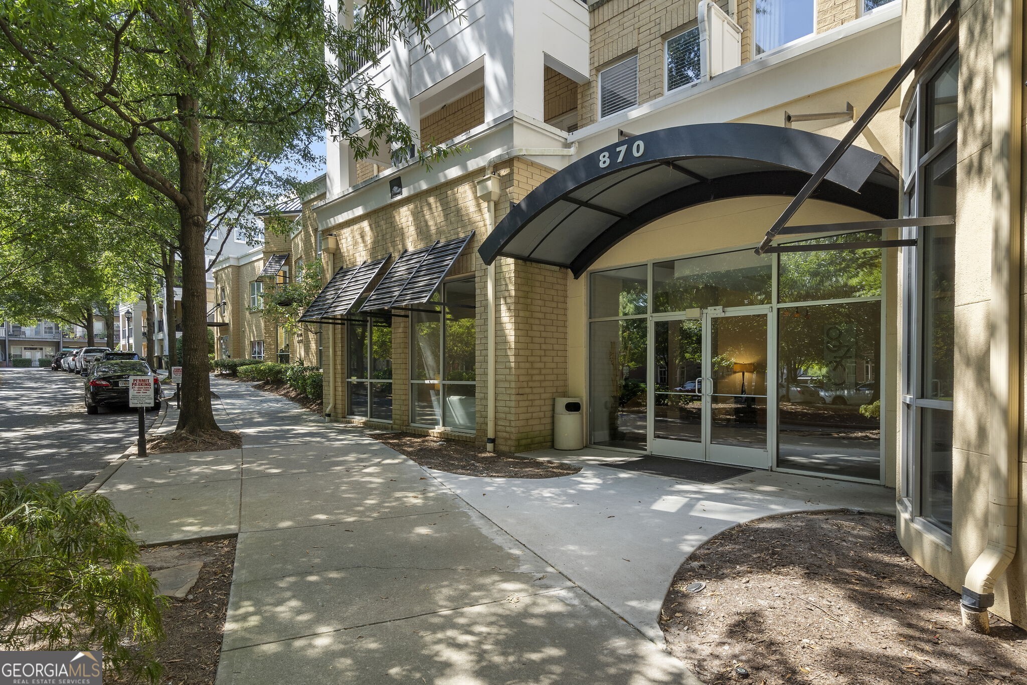 Experience refined urban living in the heart of vibrant and historic Inman Park with this beautifully updated condominium. This spacious second-floor unit features soaring 10-foot ceilings and oversized windows that flood the open-concept living space with natural light. The ambiance is further elevated by fresh, warm paint that complements the rich hardwood floors, while the newly installed kitchen hardware and modern faucets in both the kitchen and bathroom add a touch of sophistication. Thoughtful upgrades such as custom roller shades, designer lighting fixtures, and a dedicated built-in desk area create a harmonious blend of style and functionality-ideal for remote work or keeping your life organized. The kitchen is designed for both style and function, featuring stainless steel appliances, a gas range, soft-close cabinetry, solid-surface countertops, newly painted cabinets, and a convenient breakfast bar ideal for entertaining. The bright living area flows effortlessly to a private balcony, offering a serene space to enjoy your morning coffee or unwind at the end of the day. The spacious custom closet offers excellent storage and organization, while the updated bathroom adds a touch of luxury.Additional features include in-unit laundry, both front and rear entry access, and a deeded storage unit. Enjoy access to resort-style community amenities including a saltwater pool, fitness center, secure keycard building access, a welcoming lobby, and gated covered parking with an assigned space. With unbeatable proximity to Krog Street Market, Inman Quarter, top-rated restaurants, local boutiques, and green spaces, this move-in-ready home offers the perfect balance of comfort, convenience, and contemporary city living in one of Atlanta's most desirable neighborhoods.