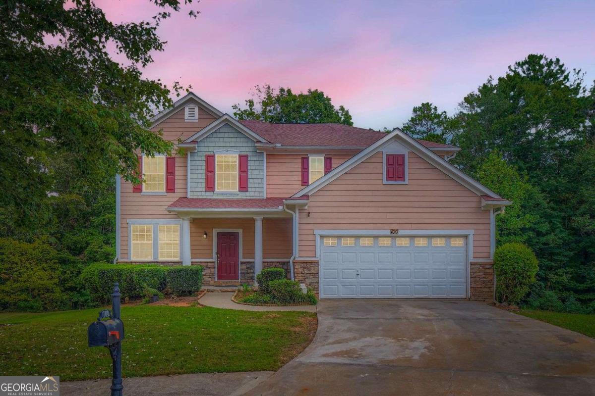 Welcome to this spacious and beautiful 4-bedroom, 3.5-bathroom home nestled in the heart of Fairburn, GA, offering warmth, comfort, and plenty of room to grow. From the moment you step inside, you're greeted by freshly redone hardwood floors that flow throughout the main level, creating a welcoming and timeless charm. The home features a fireside family room, perfect for cozy evenings gathered around the fireplace, a living room for entertaining. The large kitchen includes double ovens, an electric cooktop which can be converted back to gas and the adjacent dining room is ideal for family meals and holiday gatherings. A separate library room provides a flexible space for a home office or possible 5th bedroom. Upstairs, you'll find a huge loft, the sprawling primary suite with its own bath, designed for relaxation and privacy, two additional oversized bedrooms offer ample comfort, with generous closet space and natural light. The finished basement is a retreat of its own, featuring a separate living space, an additional bedroom, and full bathroom with step-in tub for generational living-perfect for guests, in-laws, or even rental opportunities. A two-car garage and abundant storage throughout the home provide both convenience and functionality. You'll love the spacious deck, ideal for morning coffee, grilling out, or hosting gatherings while enjoying the fresh Georgia air and the fully stocked community pond, with nearby Fairburn amenities, parks, schools, shopping, and easy access to Atlanta just a short drive away. This home is the perfect blend of space, comfort, and character, making it a wonderful place to create lasting memories.
