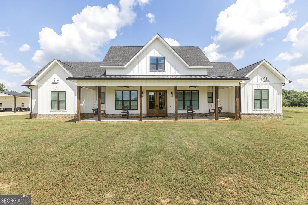 Stunning 2023 Custom- Built Home- 5 Bed / 4.5 bath + Office + Shop! Welcome to this beautiful custom-built home, offering the perfect blend of luxury, comfort, and functionality. From the inviting rocking chair front porch to the expansive open-concept living spaces, every detail has been thoughtfully designed. Inside, the gourmet kitchen boasts granite countertops, large center island, farmhouse sink, custom cabinetry, built- in microwave (convection), wall oven, and gas cooktop-all framed by a picture window above sin k overlooking views of the backyard. The living room features a gas fireplace with brick surround and shiplap accent wall,and a 4-panel sliding door that opens to the covered outdoor living space with wood burning fireplace and tongue-and-groove ceiling. Each of the 5 bedrooms and 4.5 baths are beautifully appointed. Bathrooms feature porcelain tubs,tiled surrounds, and glass shower doors. The primary suite includes 2 large vanities with granite countertops,custom walk in shower and 3rd vanity for makeup. Large walk in closet with custom built-in drawers and cabinetry. Additional interior highlights: 8' interior doors throughout, LED-lit staircase,Cat 5 cable, Foam Insulation, Tankless water heater, 3 HVAC Systems, & tinted windows. Step outside to enjoy a spacious backyard, a serene stocked pond, 30x50 shop featuring a full bath, custom water filtration system & water softener, separate hot water heater, 15x30 awning, dedicated HVAC, & Insulated garage doors. The property is complete with underground power, soffit outlets, security lighting, gutters and HUNTING & FISHING LAND GALORE to include Deer, Ducks, Dove, & Quail!! Call for your personal tour.
