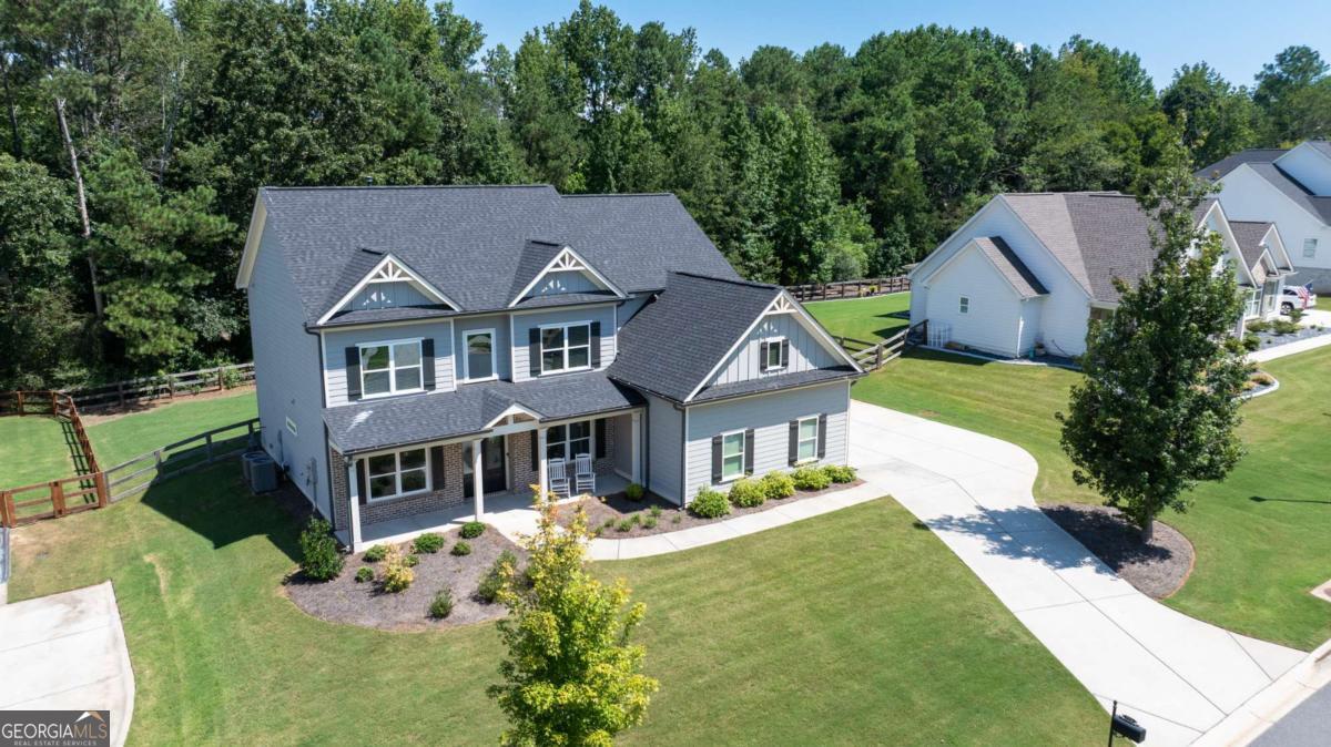 Practically brand new construction by Rivermont Homes (2022)! Welcome to this beautifully designed four-bedroom, three-bath home with three-car garage on over half an acre with a large, fenced backyard in Coopers Ridge. This beautifully maintained and well established Community has Resort style amenities featuring a pool with a slide and mushroom splash pad, clubhouse, and two lighted tennis courts / pickleball courts. Close to Lake Lanier, Minutes from GA 400, Conveniently Located to All Your Shopping Needs and Highly Sought After East Forsyth High School District. A covered front porch opens to a light-filled two-story foyer and open-concept living, perfect for entertaining. The family room greets you with a cozy fireplace and a wall of windows with serene backyard views. The new kitchen has shaker white cabinets, soft-close drawers/doors, stainless appliances, granite counters, a farmhouse sink, and a large pantry. The main level includes a guest bedroom with full bath, formal dining, and a flex room/office/den. Upstairs, the spacious primary suite has a tray ceiling, his and hers large walk-in closets, and a spa-like bath with dual vanities, soaking tub, and oversized shower. Two additional bedrooms both have large walk-in closets and share a Jack-and-Jill bath, and a loft offers flexible space for an office, craft room, playroom, or teen room. A dedicated laundry room adds convenience. The deep 3-car garage has built-ins for organization and additional storage. Enjoy a level backyard with a spacious patio, ideal for year-round relaxation and future additions. With low-maintenance exterior finishes, a security system, and access to top community amenities-this home truly has it all.