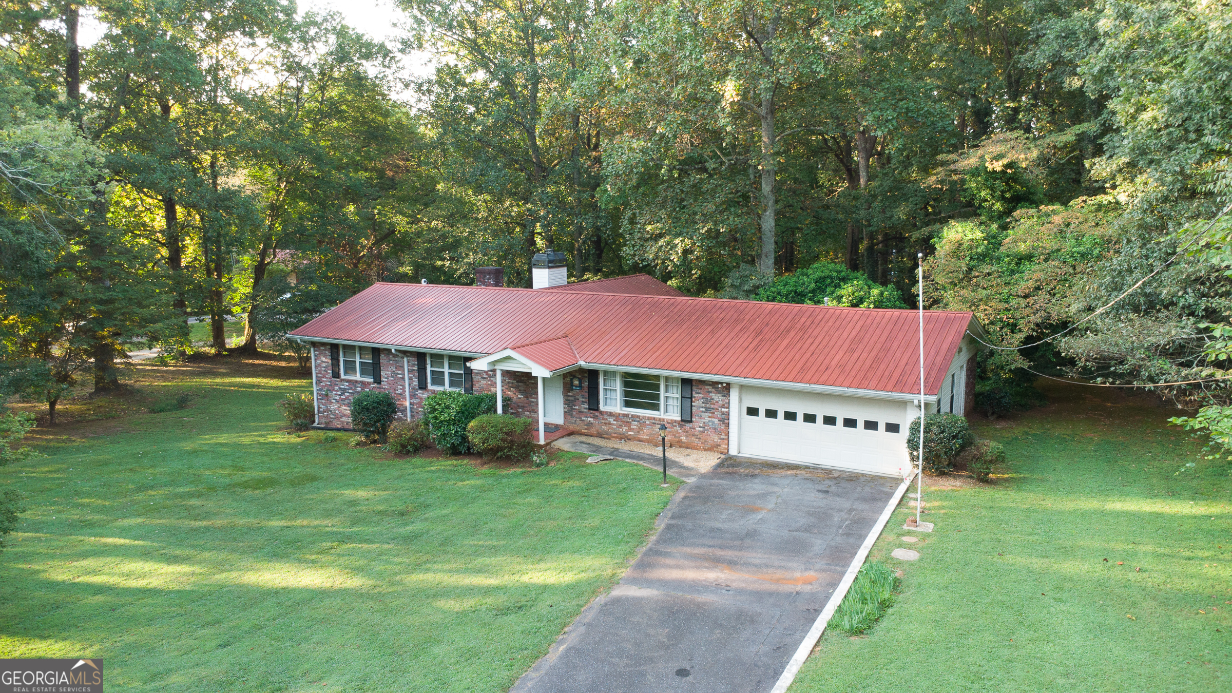 Welcome to this charming 3-bedroom, 2-bathroom ranch home perfectly situated on almost 2 private acres in the heart of Forsyth County. Offering over 2,000 square feet of living space, this property combines comfort, versatility, and convenience in one. Step inside to discover a spacious floor plan highlighted by a large extra den with its own fireplace, creating the perfect retreat for a cozy family room, home office, or even a secondary primary suite. The unfinished basement provides endless opportunities for storage, hobbies, or future expansion. Outdoors, the property truly shines. With nearly 2 acres of private land, you'll have plenty of room to garden, entertain, or simply enjoy peaceful surroundings. A small barn/shop adds bonus space for storage, a workshop, or recreational equipment. The private backyard makes the ideal backdrop for family gatherings, pets, or relaxing evenings under the stars. This home is tucked into a convenient location, just minutes from shopping, dining, and commuter routes, while still offering the serenity of country-style living. Families will love being zoned for the award-winning Forsyth County school district, one of the most sought-after in the area. And with no HOA, you'll have the flexibility to make this property truly your own. Whether you're searching for a comfortable ranch home with room to grow or a property with land and freedom, this one checks all the boxes. Don't miss the chance to make this Forsyth County gem your next home!
