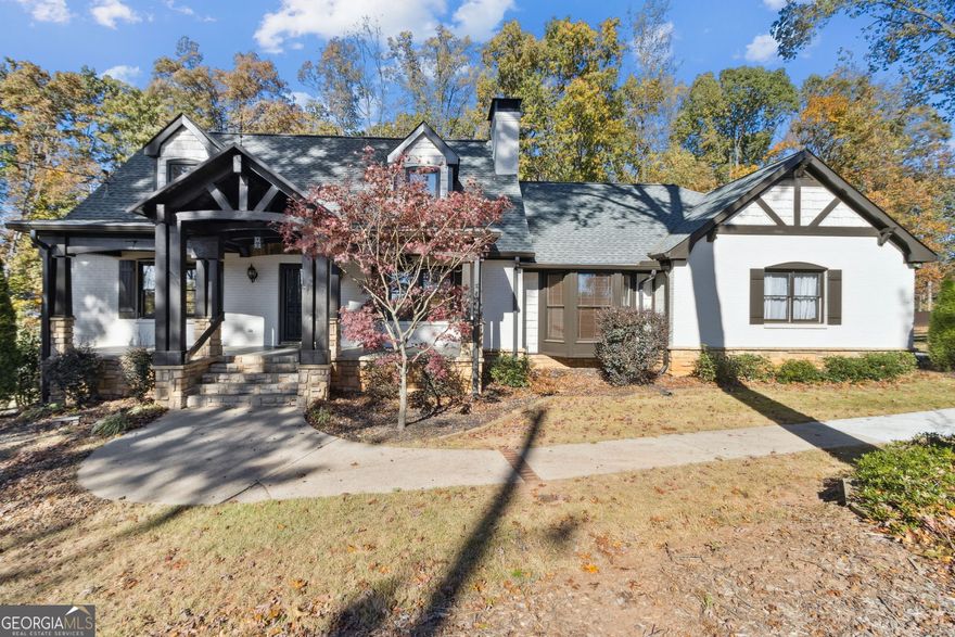 Welcome to this custom, four-sided brick home in the award-winning Buford City School District, perfectly situated on a spacious 0.63-acre lot with a full, finished basement. Step inside to an elegant entrance foyer featuring a double-tray ceiling, two-piece crown molding, and travertine flooring. The foyer opens to a stunning family room with a coffered ceiling, can lighting, a rock-masonry fireplace with gas logs, and judges' paneling. The gourmet granite kitchen features custom-stained cabinetry, stainless steel appliances, an induction cooktop, a travertine backsplash, a bay-windowed breakfast area, a pantry, a center island, and a charming planter window. The formal dining room showcases hardwood floors, judges' paneling, and a bay window wall. A bright sunroom with hardwood flooring overlooks the private backyard and leads to an oversized rear deck-ideal for entertaining. The main-level primary suite is oversized and features two closets and a spa-like bath with dual vanities and an oversized, wheelchair-accessible ceramic tile walk-in shower. The upper level features two spacious secondary bedrooms, each equipped with dual closets, dormers with window seats, and a shared full bathroom. The finished terrace level functions beautifully as an in-law or guest suite, complete with a kitchenette featuring shaker-style cabinetry, a living area with a masonry fireplace, a flex room that could serve as a fourth bedroom, a full bath, a second laundry room with a washer and dryer, and additional unfinished storage space. No HOA, No Rental Restrictions. Further highlights include: a main-level laundry room with custom cabinets, a Walk-in attic, a private and large fenced backyard with a double gate for easy access for a boat or RV, a Late-Model 30-year Architectural Roof,  Fresh exterior paint, and room for a pool. In a prime location just minutes from #1-ranked Buford City Schools and Lake Lanier. Schedule your private tour today!