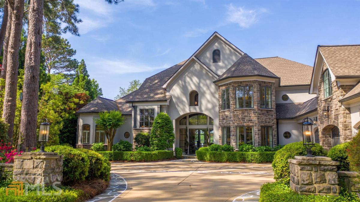 Introducing the ultimate lakefront estate in Cuscowilla on Lake Oconee. Built by DreamBuilt this custom home has timeless elegance and a main level walk-out to an expansive outdoor entertaining area and custom pool on a private level lot with gorgeous big water views and a max dock with boat lift. This 6900 square foot home had a major renovation in 2019, the rest of the home renovation was completed in 2022 which included new roof, HVAC systems and exterior painting. This masterpiece has everything that modern lifestyle demands. The luxurious main level owner's suite has amazing lake views and access to the outdoor space, two custom walk in closets, a bathroom with dual sinks, walk in shower and stand-alone tub. Outdoor spaces are created for guests to relax and enjoy all the tranquility that living on Lake Oconee has to offer. Work from home overlooking the lake in the expansive office with gaming area and access to the outdoor covered terrace on the second level which features three additional bedrooms with full baths. An additional guest suite with full bath is located above the oversized three car garage which could be used as a separate apartment or in-law suite. Cuscowilla is a top 5 rated golf club in the State of Georgia and the #1 rated course in the Lake Oconee area. Membership packages are available to enjoy the world class amenities of this golf cart friendly community including fine dining, golf, pool, tennis, pickleball, fitness, helipad, dog park and community garden. Live your best life here - come see this stunning lakefront home in this amazing golf community today!