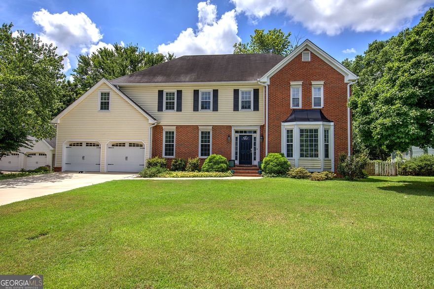 Welcome home to this inviting property offering plenty of space and charm. The spacious living room features a cozy fireplace and built-in bookshelves. A large dining room flows into the bright kitchen with an island, white cabinetry, and ample counter and storage space. Just off the kitchen, enjoy the beautiful bricked patio shaded by flowering trees, with wide brick steps leading to a level, fenced backyard with lush green grass - perfect for relaxing or entertaining.    The oversized master suite includes its own fireplace and a private bath with a large walk-in tiled shower and whirlpool tub. The fourth bedroom is generously sized, ideal for a flex space or bonus room to suit your needs.    Located just minutes from Kennesaw Mountain - walking and hiking trails, Marietta Square, shopping, and dining. Schedule your showing today - your dream home awaits! VA Assumable.
