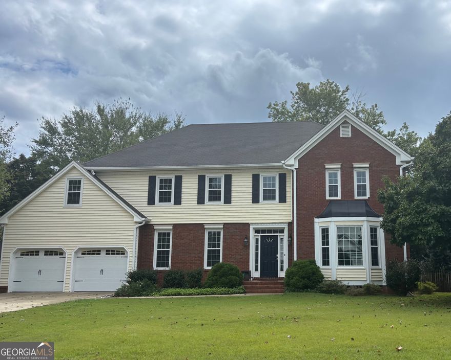 Welcome home to this inviting property offering plenty of space and charm. The spacious living room features a cozy fireplace and built-in bookshelves. A large dining room flows into the bright kitchen with an island, white cabinetry, and ample counter and storage space. Just off the kitchen, enjoy the beautiful bricked patio shaded by flowering trees, with wide brick steps leading to a level, fenced backyard with lush green grass - perfect for relaxing or entertaining.    The oversized master suite includes its own fireplace and a private bath with a large walk-in tiled shower and whirlpool tub. The fourth bedroom is generously sized, ideal for a flex space or bonus room to suit your needs.    Located just minutes from Kennesaw Mountain - walking and hiking trails, Marietta Square, shopping, and dining. Schedule your showing today - your dream home awaits! VA Assumable.