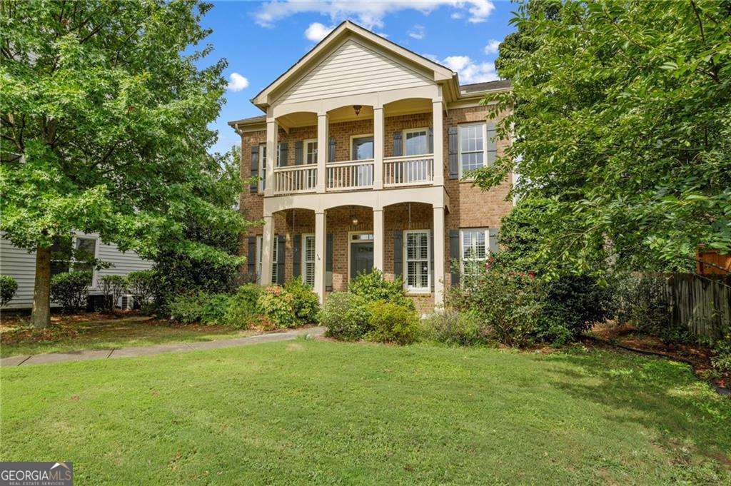 Stunning Custom-Built Craftsman Home in Eagles Grove! This exceptional home features one of the best floor plans in the community and boasts a rare, oversized partially-private front yard-perfect for entertaining or relaxing while people-watching from the main-level porch or upper-level balcony. Conveniently located within walking distance to Woodward Academy Main Campus and directly across from Woodward's practice fields, this home offers both charm and practicality. This brick-front beauty includes 4bedrooms/3.5 bathrooms and hardwood floors throughout the main level. The 2-car garage is complemented by additional parking space for 2-3 cars on the side parking pad or in front of the garage. Two park-like green spaces within the community are ideal for soccer, walking your pups or taking an afternoon stroll. Inside, you'll find a cozy living room with a gas brick fireplace and a spacious kitchen featuring granite countertops and a view into the living room. The eat-in breakfast area is paired with a formal dining room, complete with elegant columns, wainscoting and a plate ledge, accommodating 12+ guests. All bedrooms are generously sized, including a guest room with a double closet-perfect for dedicating one to shoes-and its own private bathroom. The oversized primary suite boasts a large walk-in closet, a separate jetted tub and shower and plenty of natural light. Additional features include an irrigation system for the front and back yard, 6+ security cameras around the property, a water filtration system under the kitchen sink, a partially fenced yard and gorgeous rose bushes that add a touch of charm to the landscaping. Schedule your showing today and experience the elegance, convenience and unmatched character of this beautiful home! Priced under recent sales in community for a quick sale. Seller is a licensed real estate agent in State of GA.