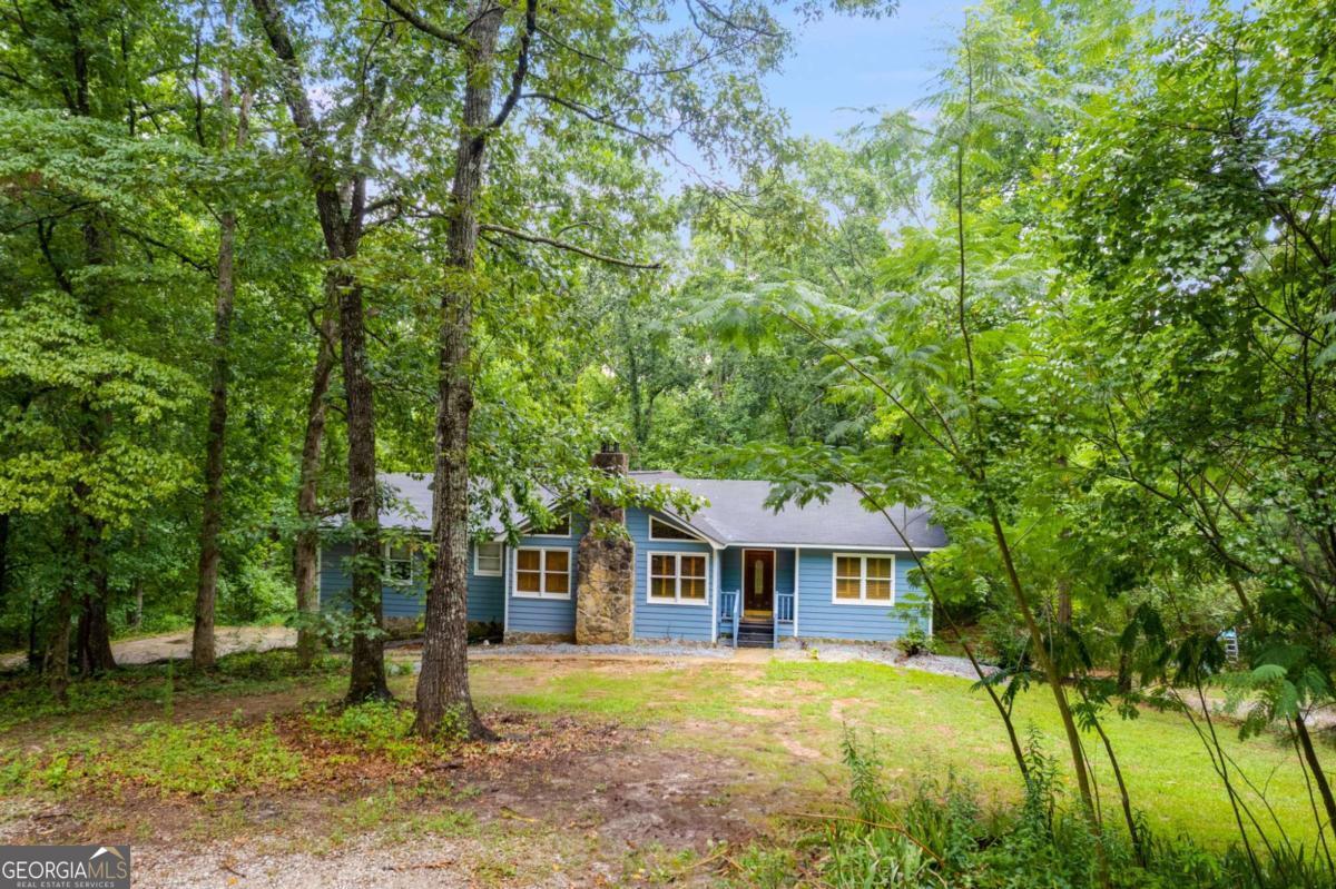 Dramatic price reduction, being sold as is, tons of equity to be had! Charming 4-Bedroom Home on 5+ Acres with Creek Access Priced to Sell! Tucked away in the heart of Winston, Georgia, this beautiful 4-bedroom, 3-bath home is sitting on five acres, offering privacy, potential, and incredible value. The property once featured scenic riding trails leading to the creek that feeds Dog River-while slightly grown over, they can easily be restored to their former beauty, creating a truly serene outdoor retreat. Inside, the home boasts original hardwood floors that, with refinishing, will shine as a true masterpiece. While it does need some updating, the home is completely livable, allowing you to renovate at your own pace while building major equity. Located in the best school district in the county and just 10 minutes from all necessities, this property offers the best of both worlds-seclusion and convenience. With a dramatically reduced price, this home is priced to sell! Don't miss out on this rare opportunity to own a private slice of country paradise.