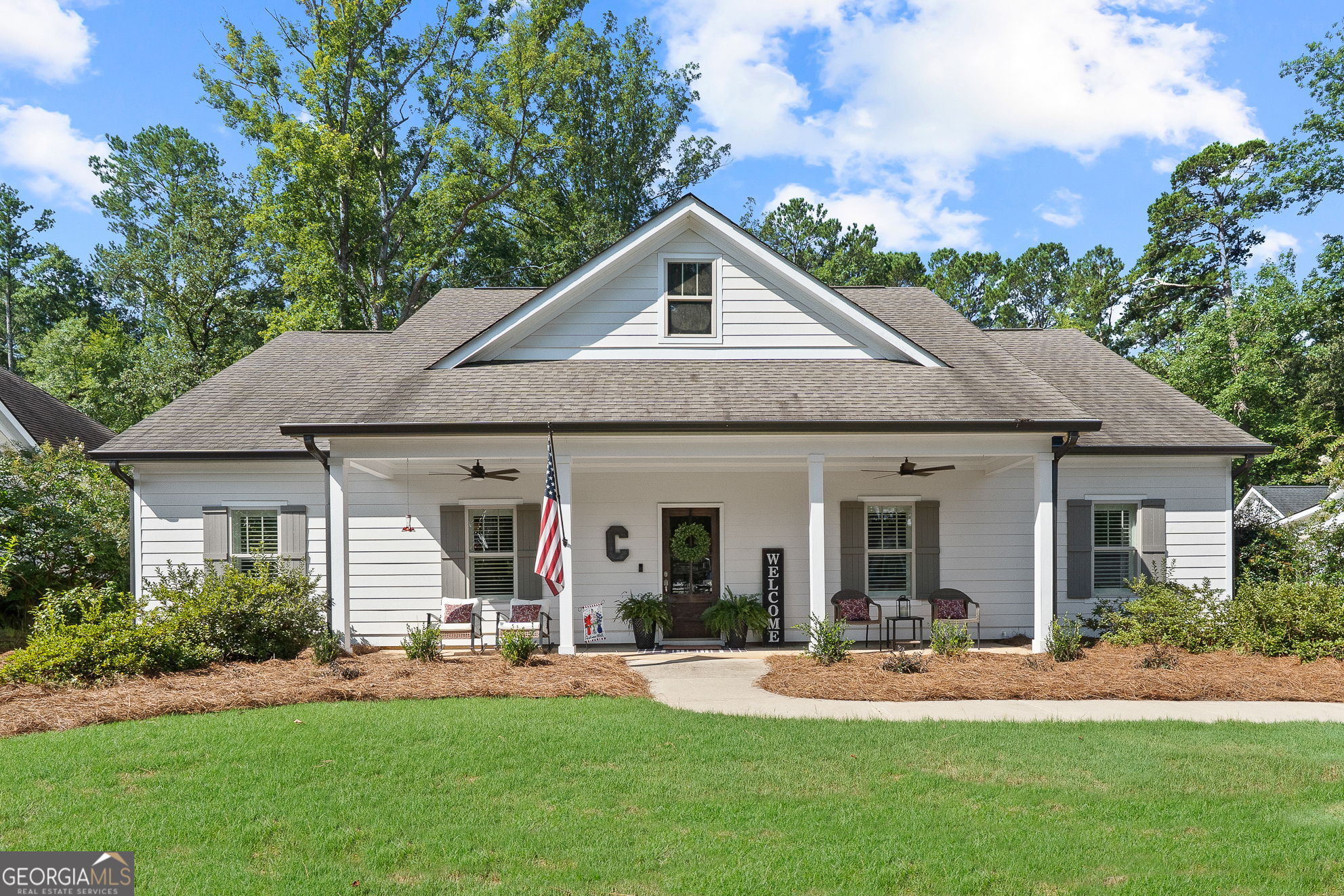 Walkable Madison Living with Modern Upgrades! Built in 2018, this 3-bedroom, 2.5-bath home offers a thoughtfully designed open concept floor plan, loaded with custom touches throughout. The chef's kitchen is a showstopper, featuring a KitchenAid gas range, quartz countertops, a large island, and plenty of workspace for cooking and entertaining. Custom tile accents run throughout all wet areas, adding both style and durability. A split floor plan ensures privacy, with the primary suite tucked away from the secondary bedrooms. There's also a dedicated office/flex room, perfect for working from home or hobbies. The custom laundry room adds style and function, while the detached two-car garage offers additional storage. Outside, enjoy a zero-maintenance backyard with newly installed astro turf and a brand-new playground, perfect for year-round play without the upkeep. Located in a beautiful neighborhood within the Madison city limits, you're just a short stroll from charming downtown shops, dining, and local events. Experience the perfect blend of small-town charm and modern living, all on one level!