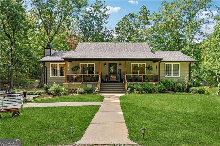 Don't miss out on this beautifully done raised ranch that has been so loved by one owner. It's time for this 6.43 acres to be home to a new family that will love it as much as the Seller's family has! The 3 bedroom, 2 bath home sits on a daylight unfinished basement so there is room to grow if you need additional bedrooms or flex space. The first thing you'll see upon entering is the large stately great room with floor to ceiling wooden bookshelves flanking a gorgeous stone fireplace. Find the floorplan in the images and you can see the separate dining room just off the great room so you can enjoy the fireplace while you have dinner. An eat in, country kitchen connects to the dinning room and also leads out to the expansive multi-tier deck that overlooks the absolute DREAM of a backyard complete with a pond, dock, stalled building, garden and an adorable outbuilding that can be a playhouse for the kids or space for your chickens.  The Seller once had horses here so plenty of room for that if your horses need a home too.  The 2 car garage is currently open to the basement so if you have boats, jet skis, etc you would have space to pull them in and still have room for your vehicle. Being just a short trek to Allatoona lake who wants to pay extra to store when you have this space already?? If you begin at the road you'll notice two graveled entrances to the property that connect via a wrap around drive. Pulling boats, campers, etc are a breeze with the in and out drive. Each of the driveways serves the one home but if a second homesite is in the plan you can utilize the second drive and road frontage to build another home , barn, etc. Currently the property is using public water but was once on a well so the possibility remains for the next owner to have a well.     Can't beat the location with an approximate 10 miles west to I-75 and 10 miles east to I-575. Shopping close in both Canton and Cartersville with easy access to boat ramps and campgrounds on  Allatoona Lake. The up and coming City of Emerson is a few exits away and you can be at a Braves game in close to 30 minutes. Come see this property where suburbia meets the country!