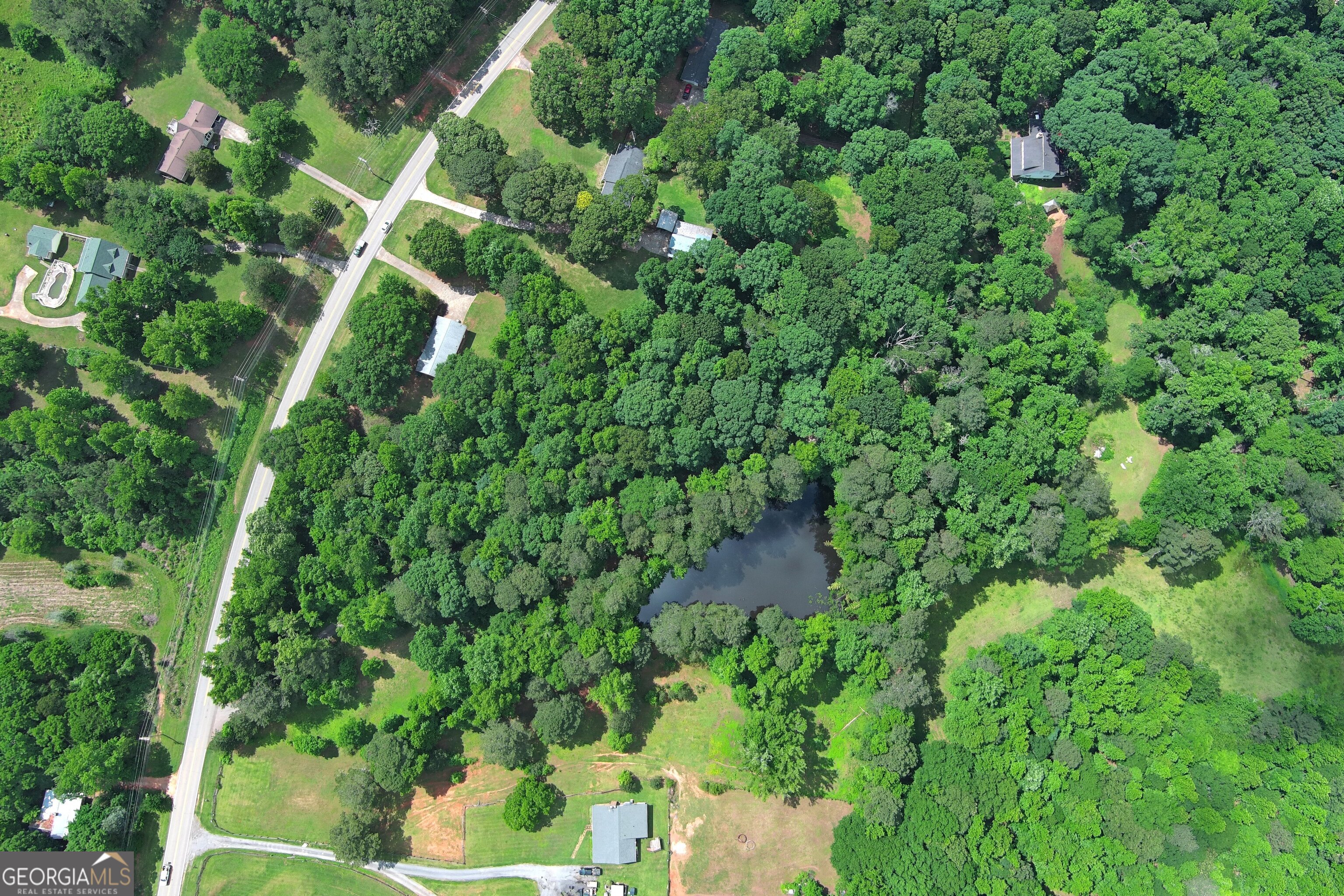 Welcome to your own private oasis! This stunning 3.957-acre corner parcel of land is a rare find, enveloped by majestic, mature trees that provide both beauty and privacy. also features your very own fishing pond, perfect for relaxing or casting a line.This picturesque setting offers ample space to build your dream home, with plenty of room for gardens, outdoor entertainment areas, and more. Whether you envision a cozy retreat or a grand estate, this land is a canvas awaiting your vision.