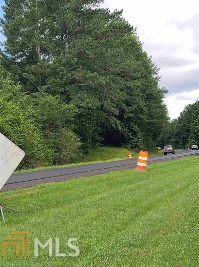 Over 1,000 ft of road frontage on Hollywood Hwy. Would make a great commercial lot, businesses are already located across from property. With 9.56 acres and NO restrictions a working open to the public minifarm or a farm to table venue could be a possibility. Proximity of less than 5 miles to 441 a four lane highway, main artery to Clayton, Dillard, Highlands, and 441 business district the possibilities are endless.