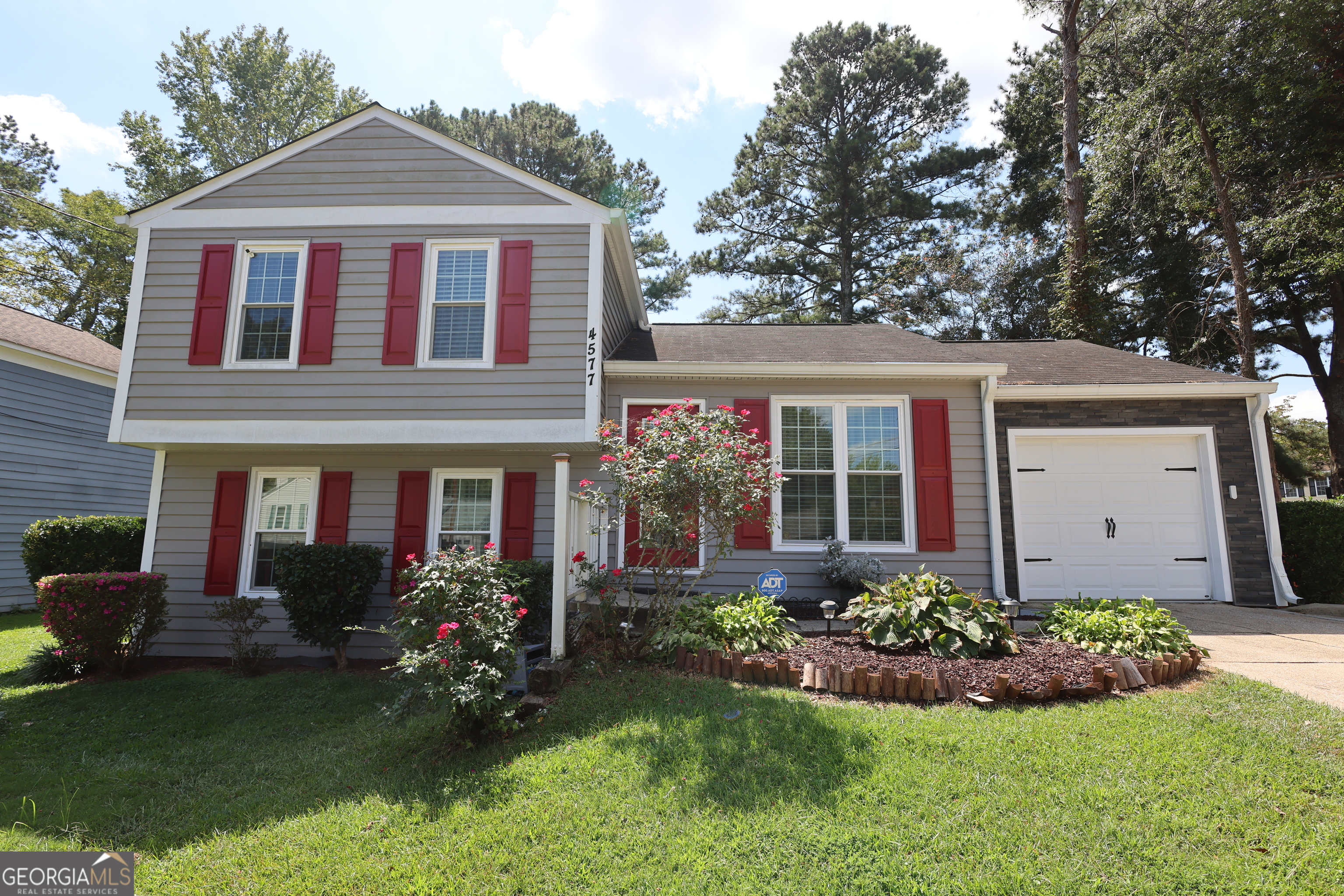 Welcome to the cutest house on the block! This charming 3-bedroom, 2-bath split-level home offers a great layout with plenty of living space. The main level features a welcoming entry, kitchen, and dining room. Just a few steps down, you'll find a cozy family room with fireplace along with a bedroom and full bath. Upstairs offers a spacious master suite, a third bedroom, and another full bath with a tub/shower. Enjoy outdoor living at its best with a covered pavilion, fire pit, and large fenced backyard - perfect for relaxing or entertaining. The home also includes a one-car garage. Don't miss out on this gem!